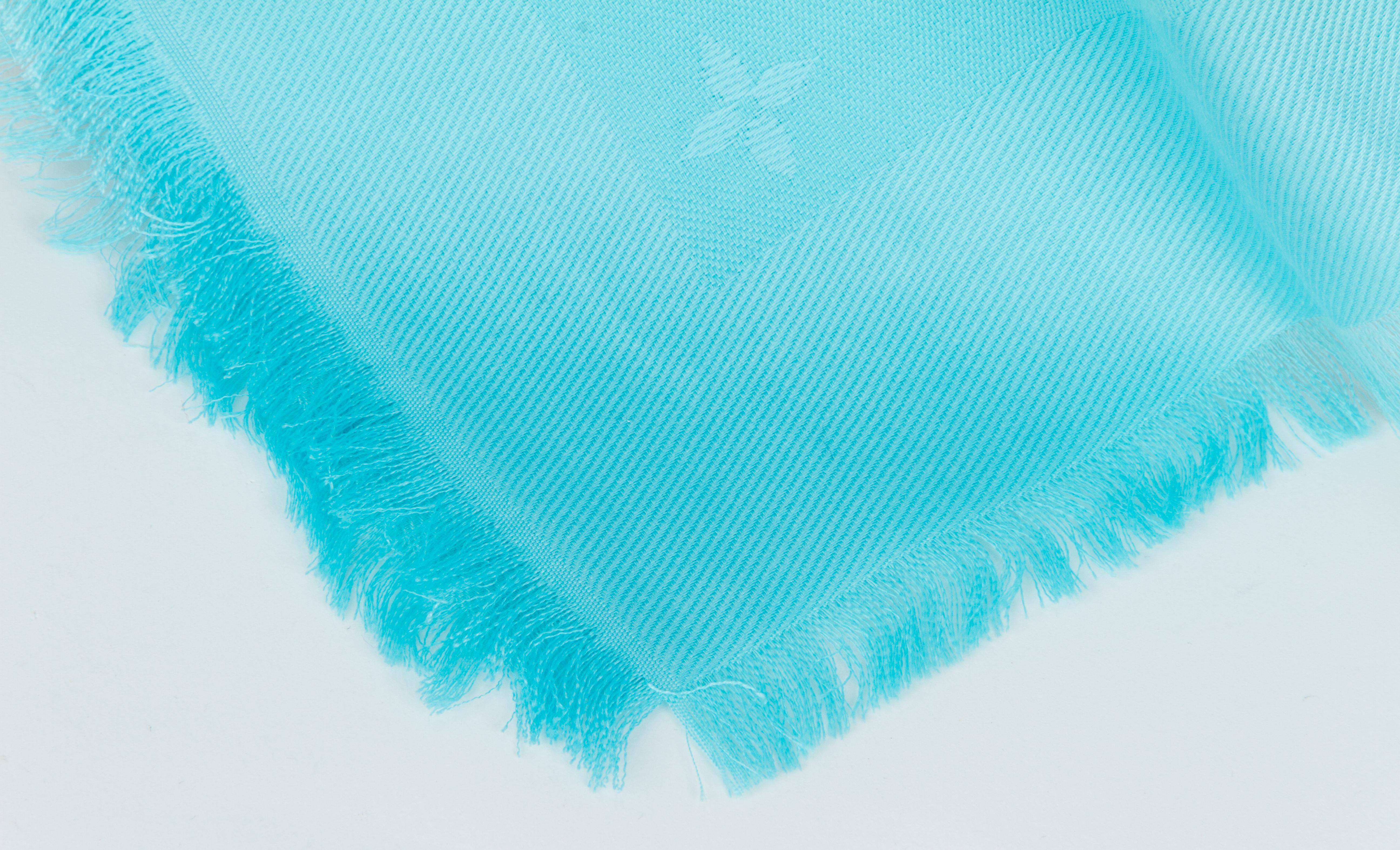 Louis Vuitton limited edition oversized turquoise silk and wool shawl with basketballs and logos design. Jacquard weave. Fringe finish.