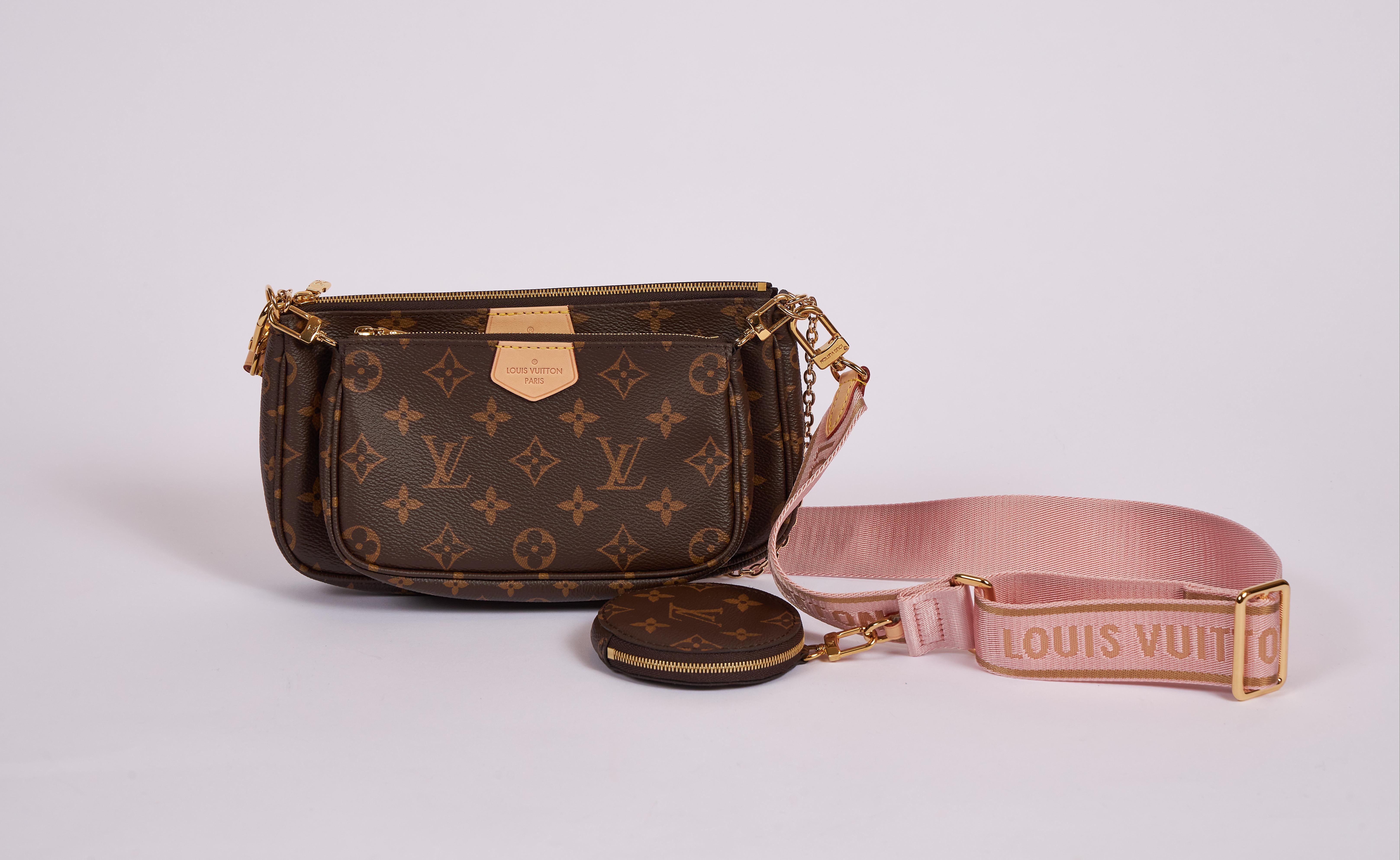 Vuitton hot season ticket multi pouches in coated monogram canvas and pink detail. Sold out worldwide . Composed of three detachable parts : cross body, pochette and round coin purse. Adjustable strap. Comes with dust cover and original box.