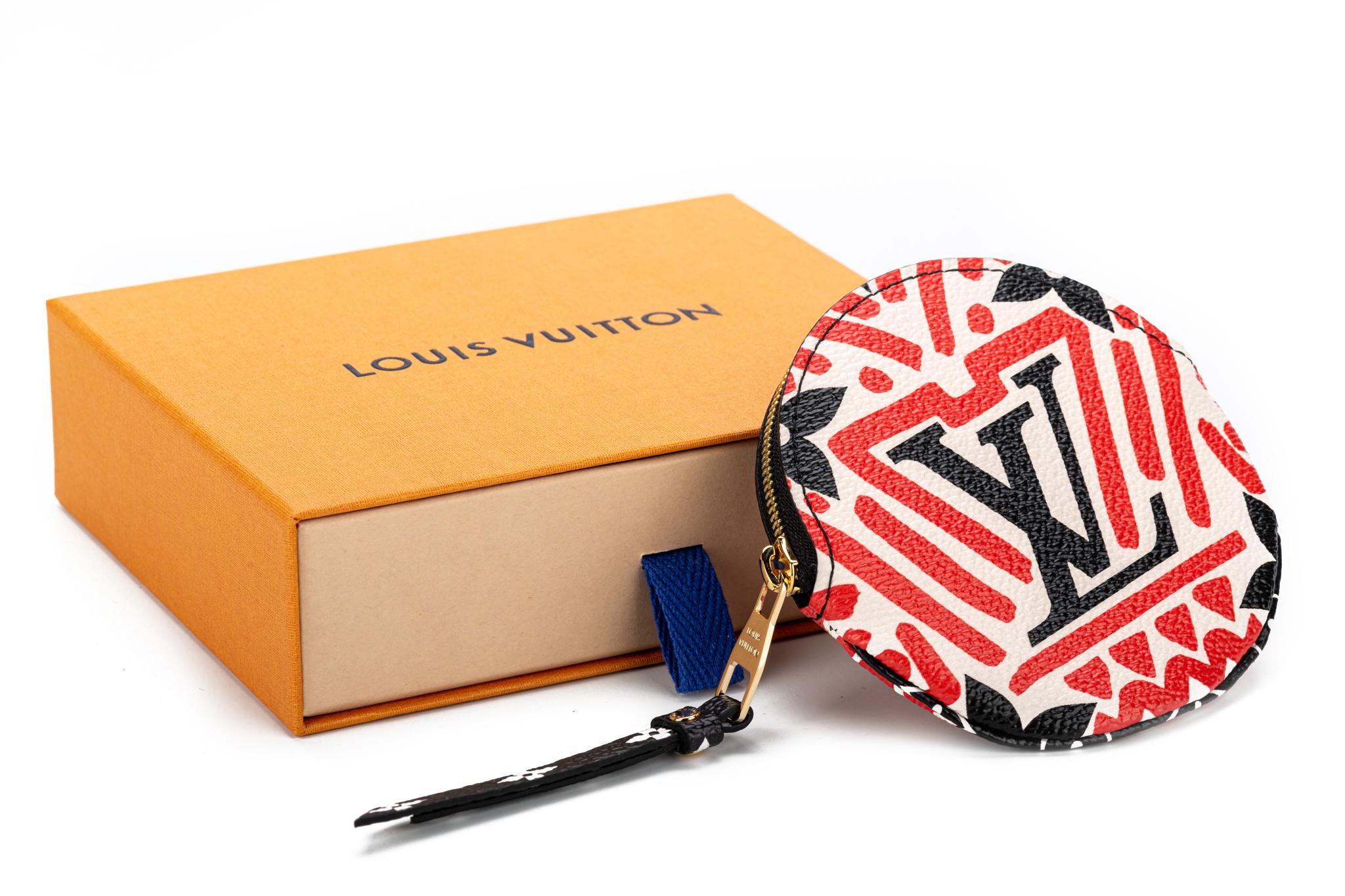 Louis Vuitton limited edition tribal round coin purse. Monogram coated canvas with black leather trims. Brand new with dust cover and box.