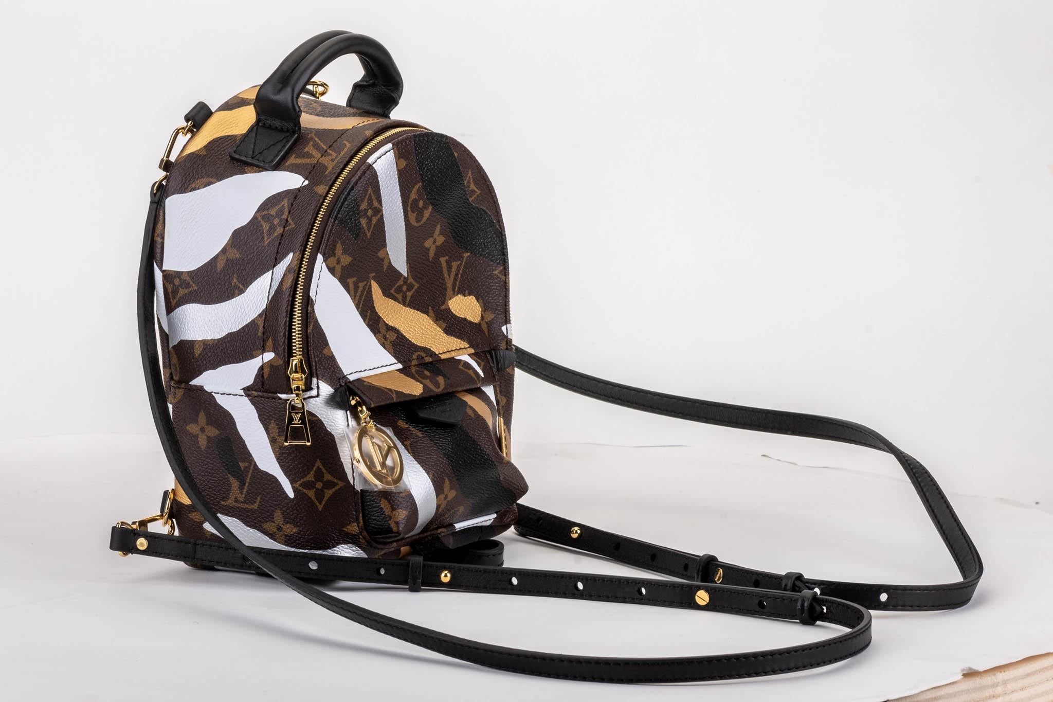Louis Vuitton limited edition camouflage mini backpack. Monogram signature canvas with black leather straps. External zipped pocket, internal open pocket. Comes with serial number, dust cover and box.