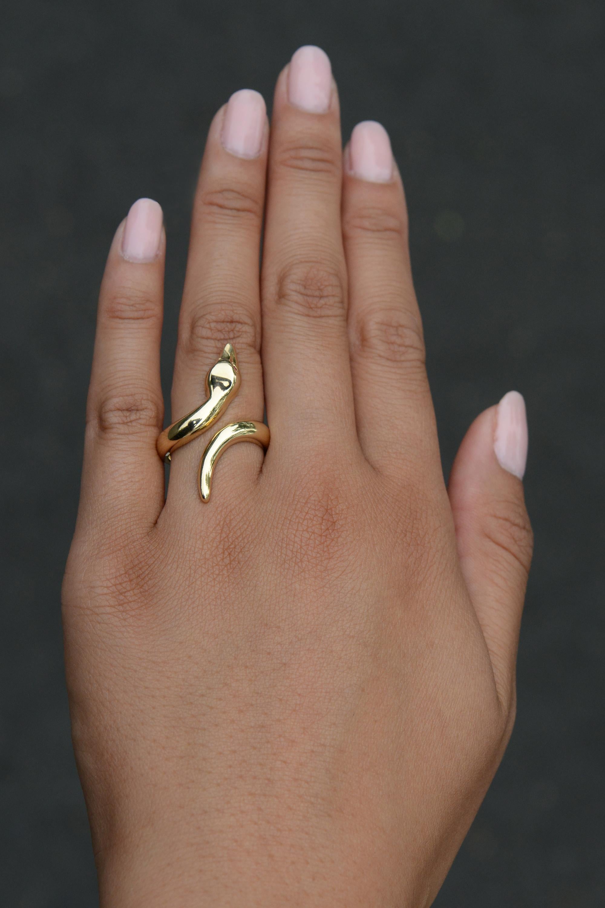 An affordable way to bring a touch of luxury into your wardrobe, this stupendous snake ring boasts over 4 grams of rich, glowing 14kt yellow gold. Its contemporary, Italian design features a slithering serpent with striking ruby eyes. A perfect,