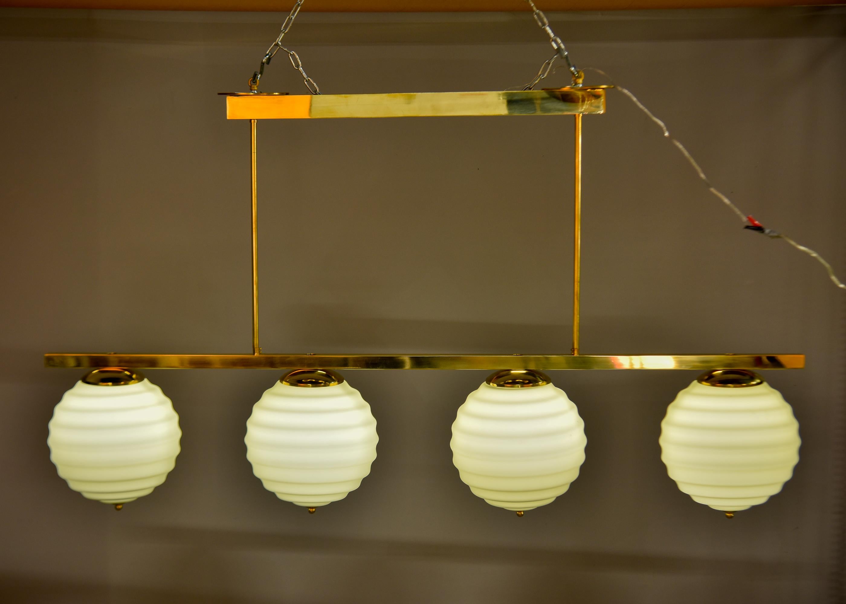 New Italian Fixture with Four Pale Taupe Globes on Horizontal Brass Bar For Sale 5