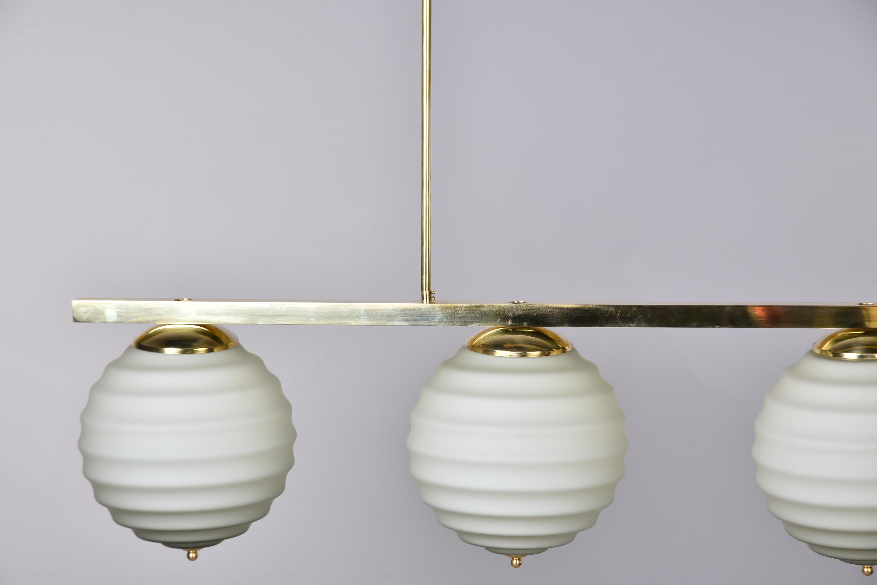 New Italian Fixture with Four Pale Taupe Globes on Horizontal Brass Bar For Sale 6