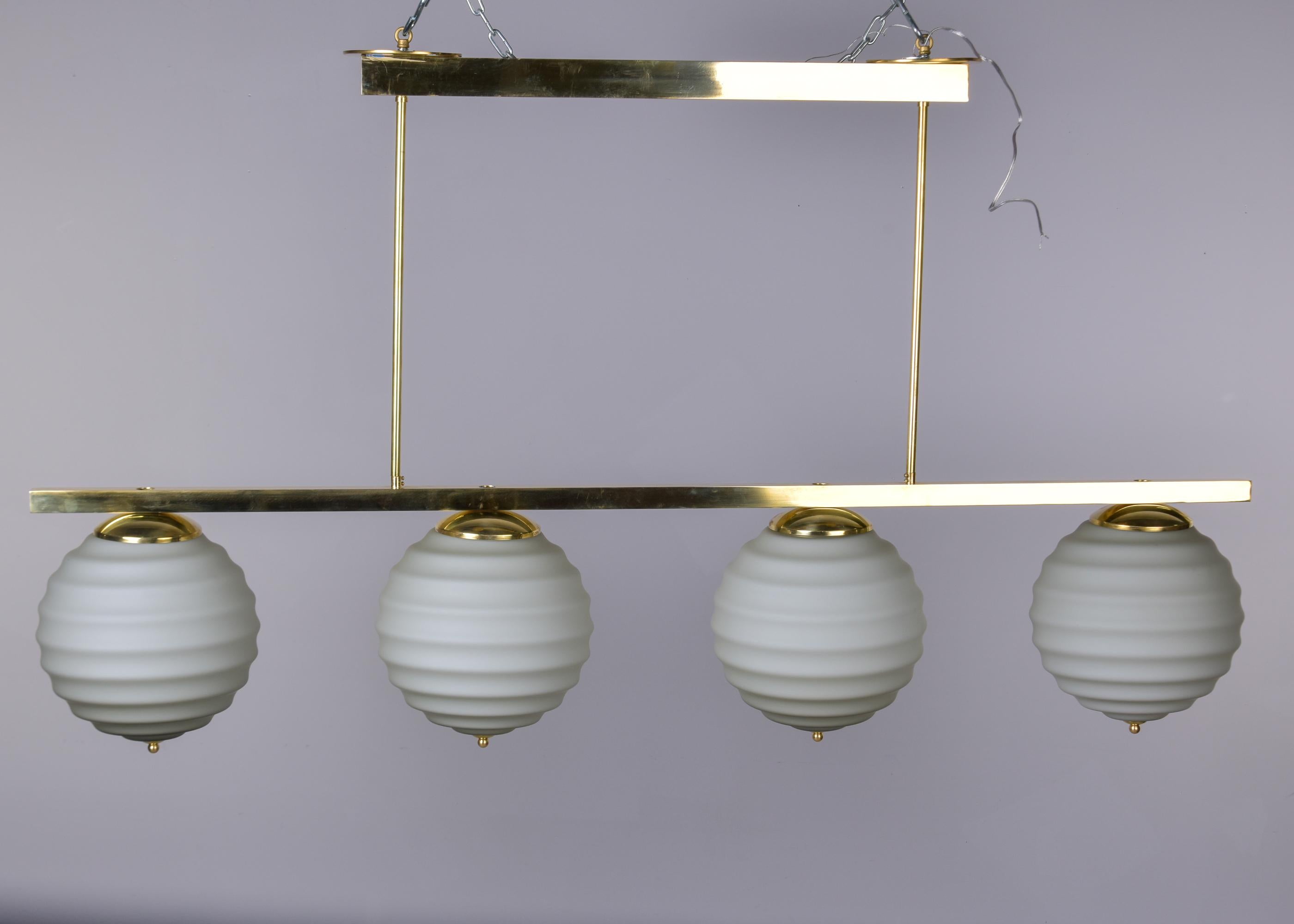 Mid-Century Modern New Italian Fixture with Four Pale Taupe Globes on Horizontal Brass Bar For Sale