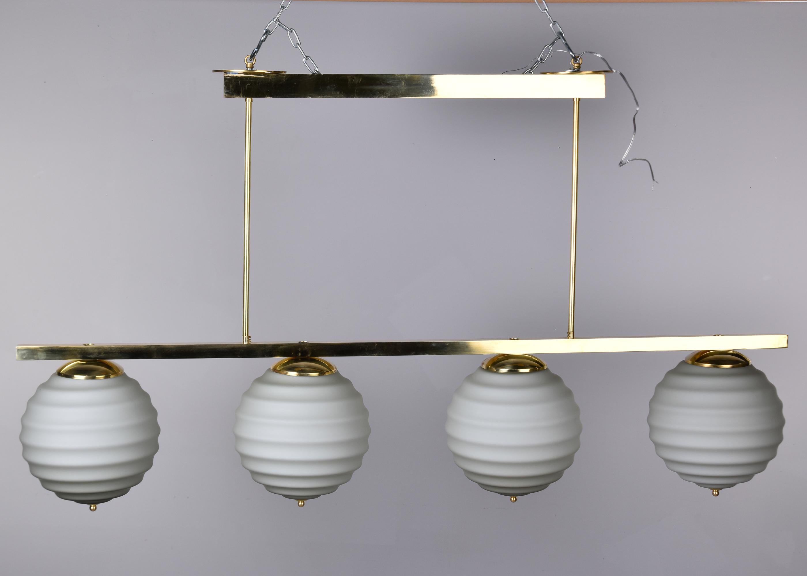 New Italian Fixture with Four Pale Taupe Globes on Horizontal Brass Bar In New Condition For Sale In Troy, MI