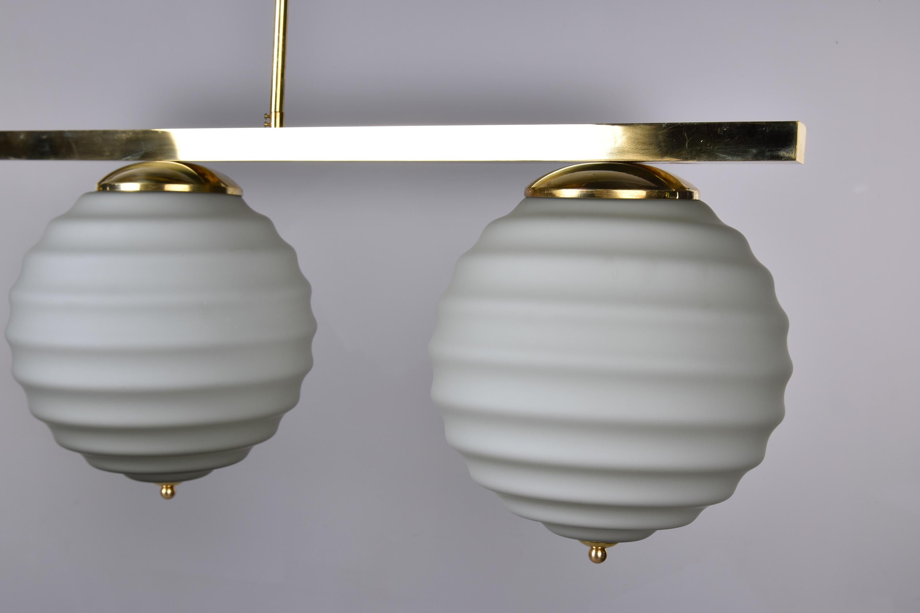 New Italian Fixture with Four Pale Taupe Globes on Horizontal Brass Bar For Sale 1