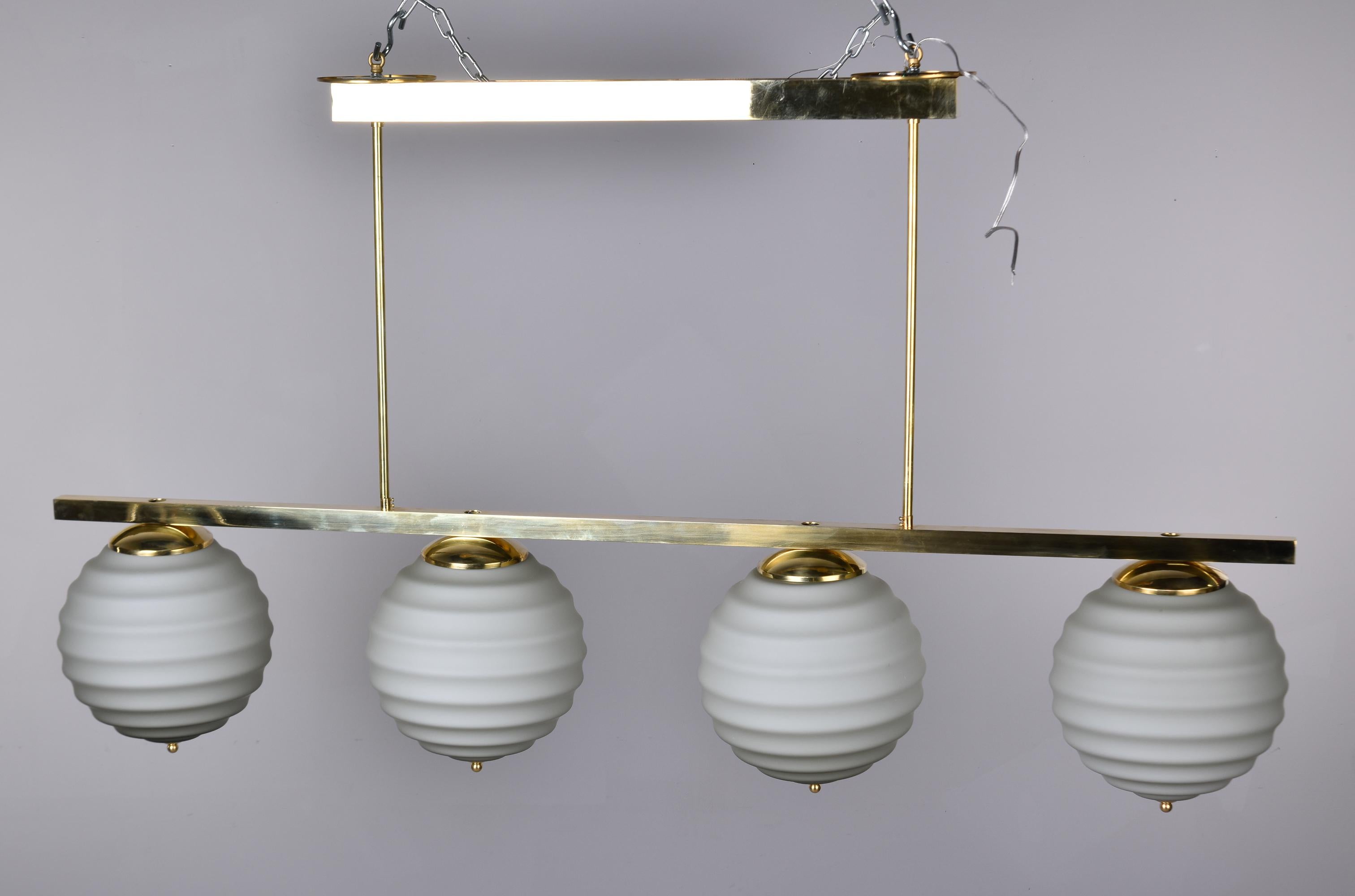 New Italian Fixture with Four Pale Taupe Globes on Horizontal Brass Bar For Sale 2