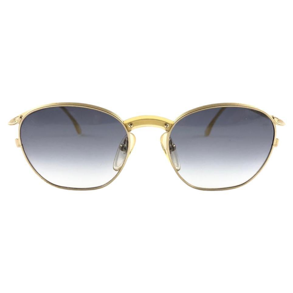 New Jean Paul Gaultier medium gold frame. 
Gradient blue lenses that complete a ready to wear JPG look.

Amazing design with strong yet intricate details.
Design and produced in the 1990's.
New, never worn or displayed.
This item may show minor sign