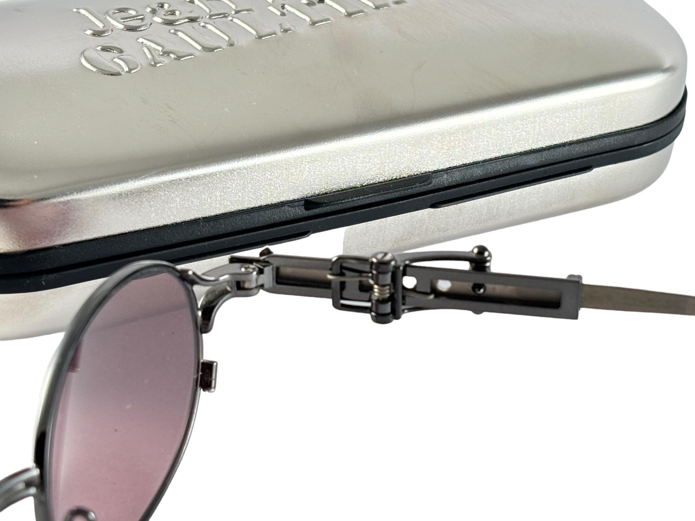Superb Collectors Item!!
New Jean Paul Gaultier 56 0020 Mouse trap ornamented  Silver Metal Ornaments Frame, sporting an intricate system to elongate the temples to the perfect measurement for the  wearer.
Spotless Dark purple Lenses That Complete A