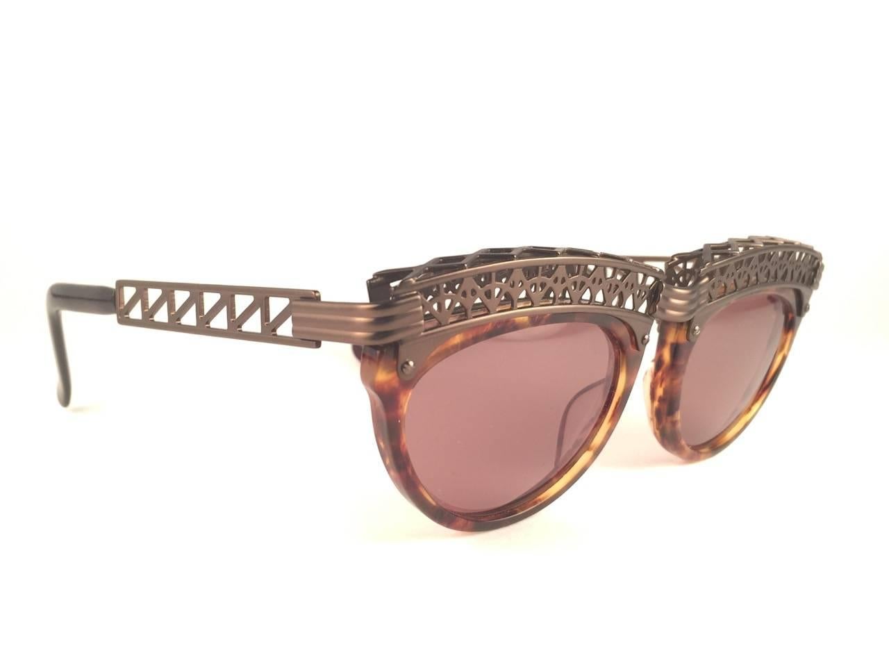 Superb Collectors Item!!
New Jean Paul Gaultier 56 0271 Eiffel Tower Copper Ornaments over tortoise frame. 
Spotless dark amber lenses that complete a ready to wear JPG look.

Amazing design with strong yet intricate details.
Design and produced in