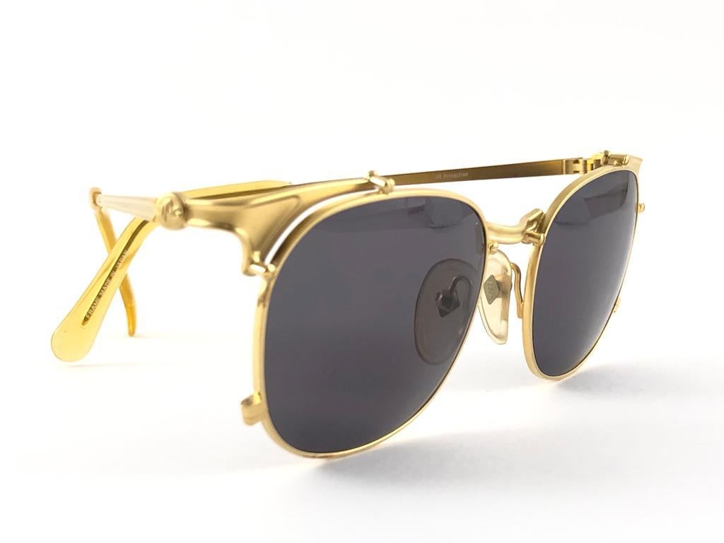 New Jean Paul Gaultier 56 42175 gold matte frame.  
Brown medium lenses that complete a ready to wear JPG look.  
Amazing design with strong yet intricate details. 
Design and produced in the 1990's. New, never worn or displayed.
A true fashion
