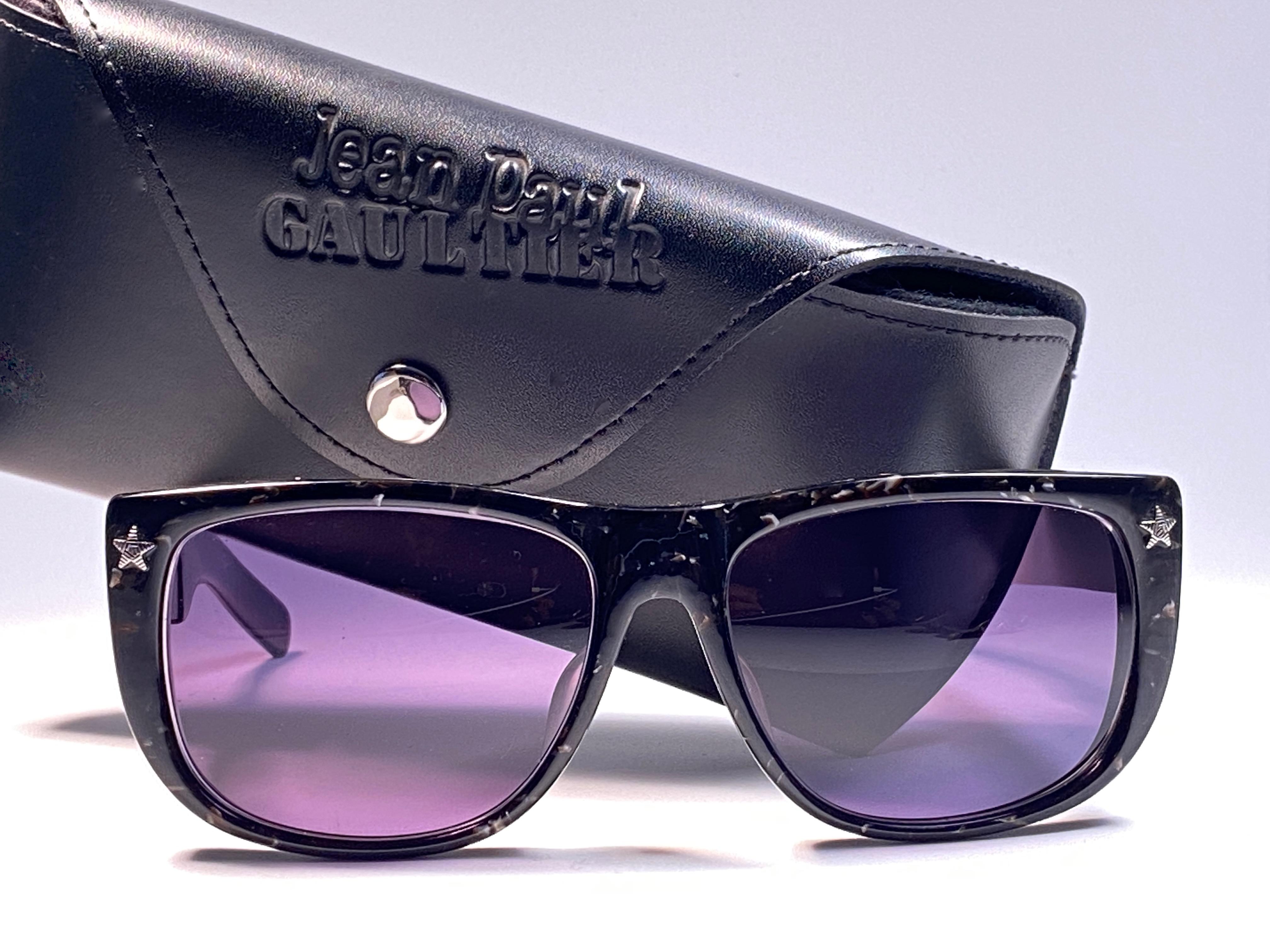 New Collectors Item!!

New Iconic Jean Paul Gaultier 56 8272 Black marbled Silver Matte temples frame. 
Dark blue lenses that complete a ready to wear JPG look.
The very same model worn by Vanilla Ice in 1990's.
Amazing design with strong yet