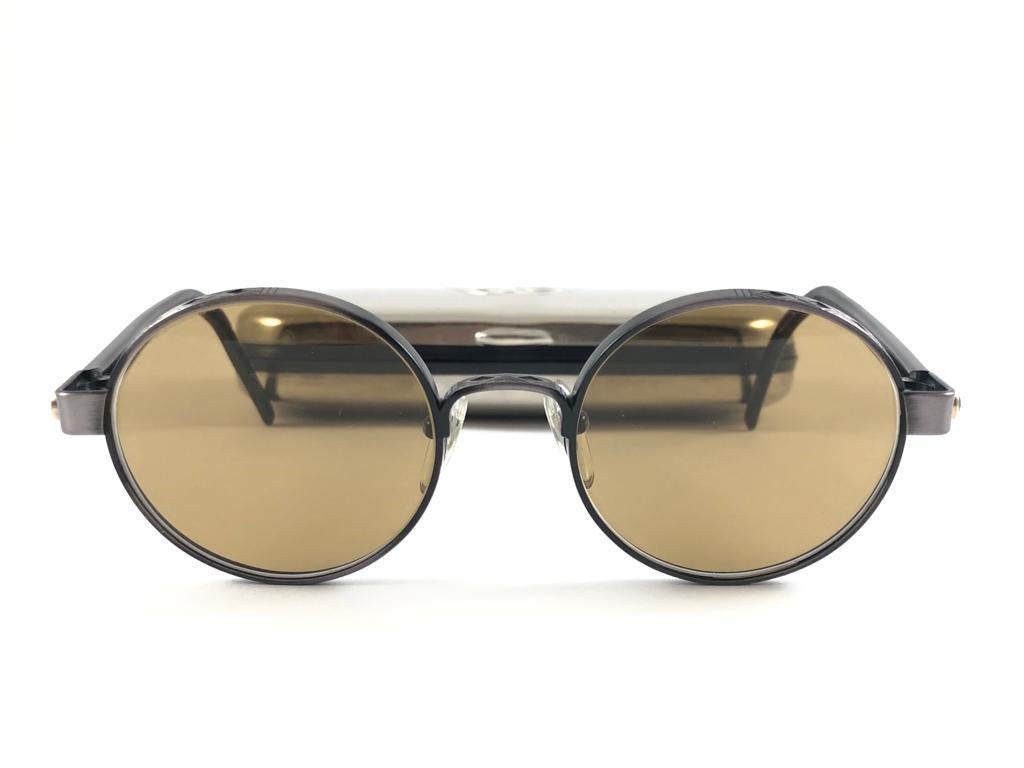 
New Jean Paul Gaultier 56 9274 Round Space Grey Frame.  Medium Brown Lenses That Complete A Ready To Wear Jpg Look. 
Amazing Design With Strong Yet Intricate Details. A True Fashion Statement. This Item May Show Very Light Sign Of Wear  Due To