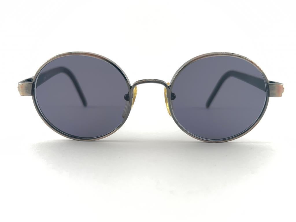 
New Jean Paul Gaultier 56 9274 Round Space Grey Frame.  Medium grey Lenses That Complete A Ready To Wear Jpg Look. 
Amazing Design With Strong Yet Intricate Details. A True Fashion Statement. This Item May Show Very Light Sign Of Wear  Due To