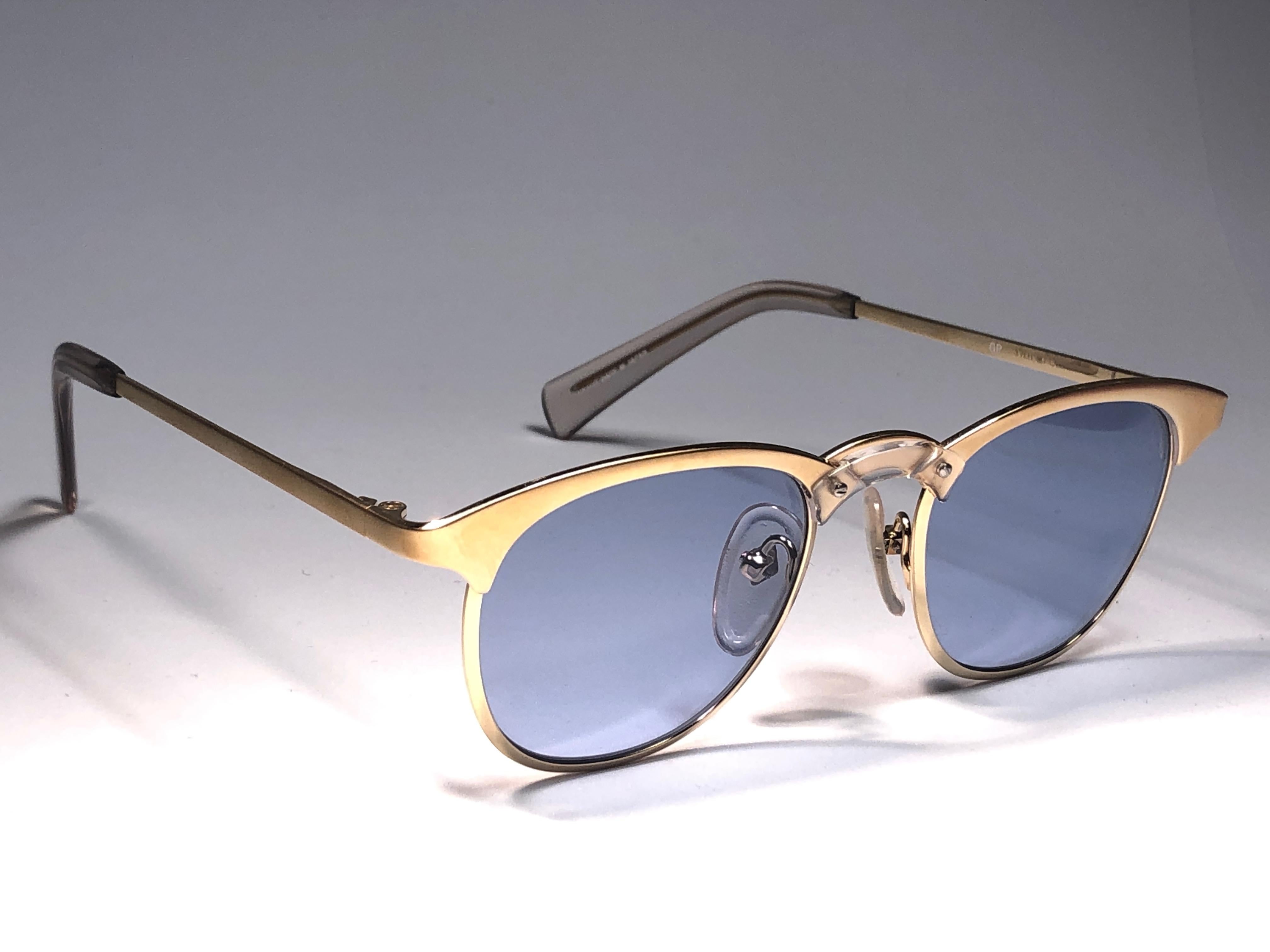 New Jean Paul Gaultier medium gold frame. 
Spotless light blue lenses that complete a ready to wear JPG look.

Amazing design with strong yet intricate details.
Design and produced in the 1990's.
New, never worn or displayed.
This item may show