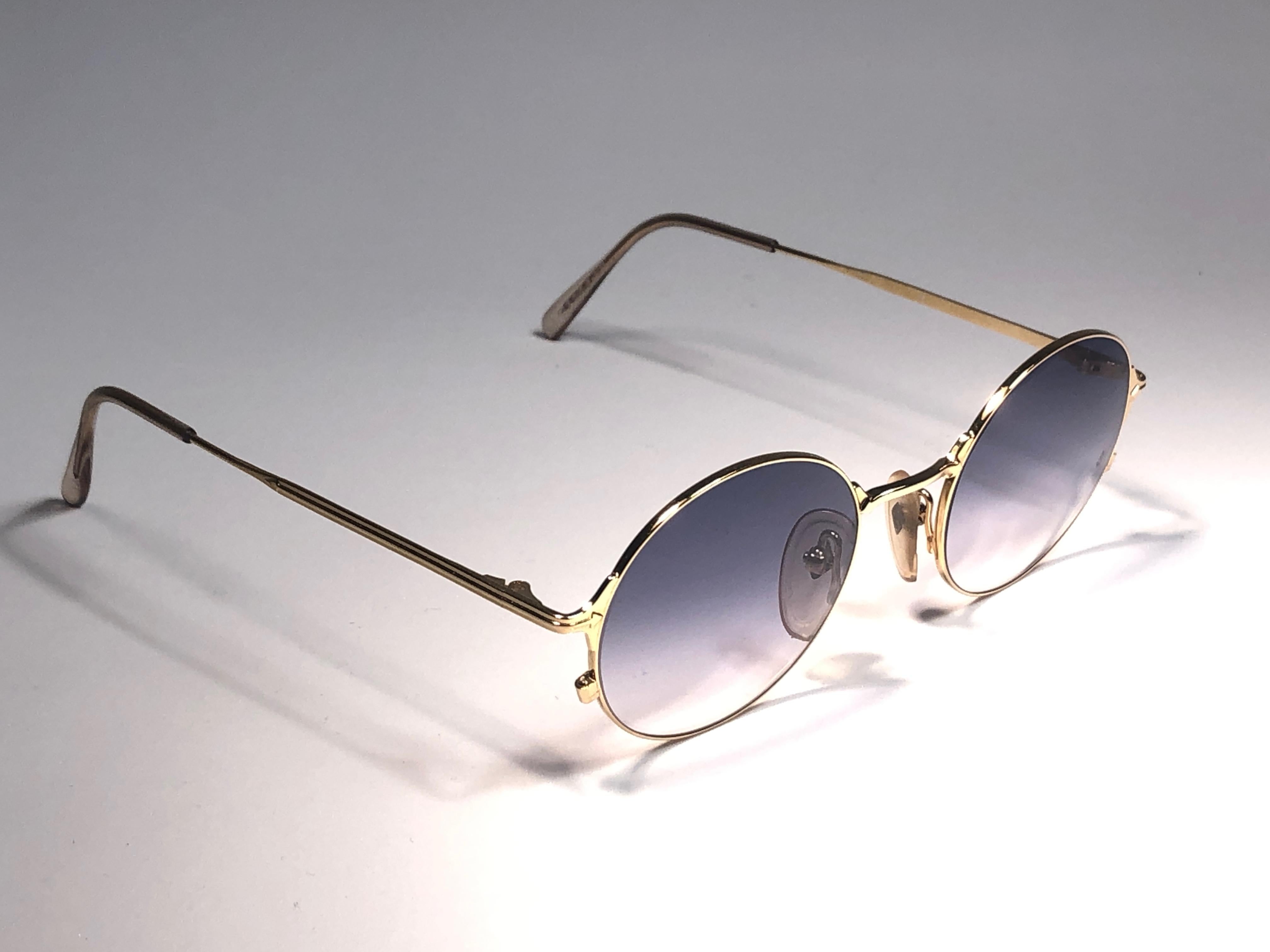 New Jean Paul Gaultier medium gold frame. 
Spotless light blue lenses that complete a ready to wear JPG look.

Amazing design with strong yet intricate details.
Design and produced in the 1990's.
New, never worn or displayed.
This item may show