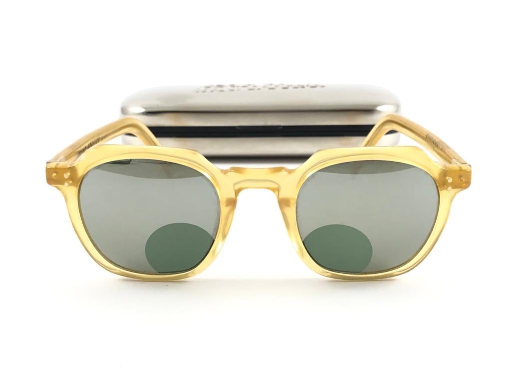 

New Jean Paul Gaultier 58 0071 Yellow Translucent frame with round keyhole accent on the mirror lenses, to read ( or to simply, spy ) 

Amazing design with strong yet intricate details.
Design and produced in the 1900's.
New, never worn or