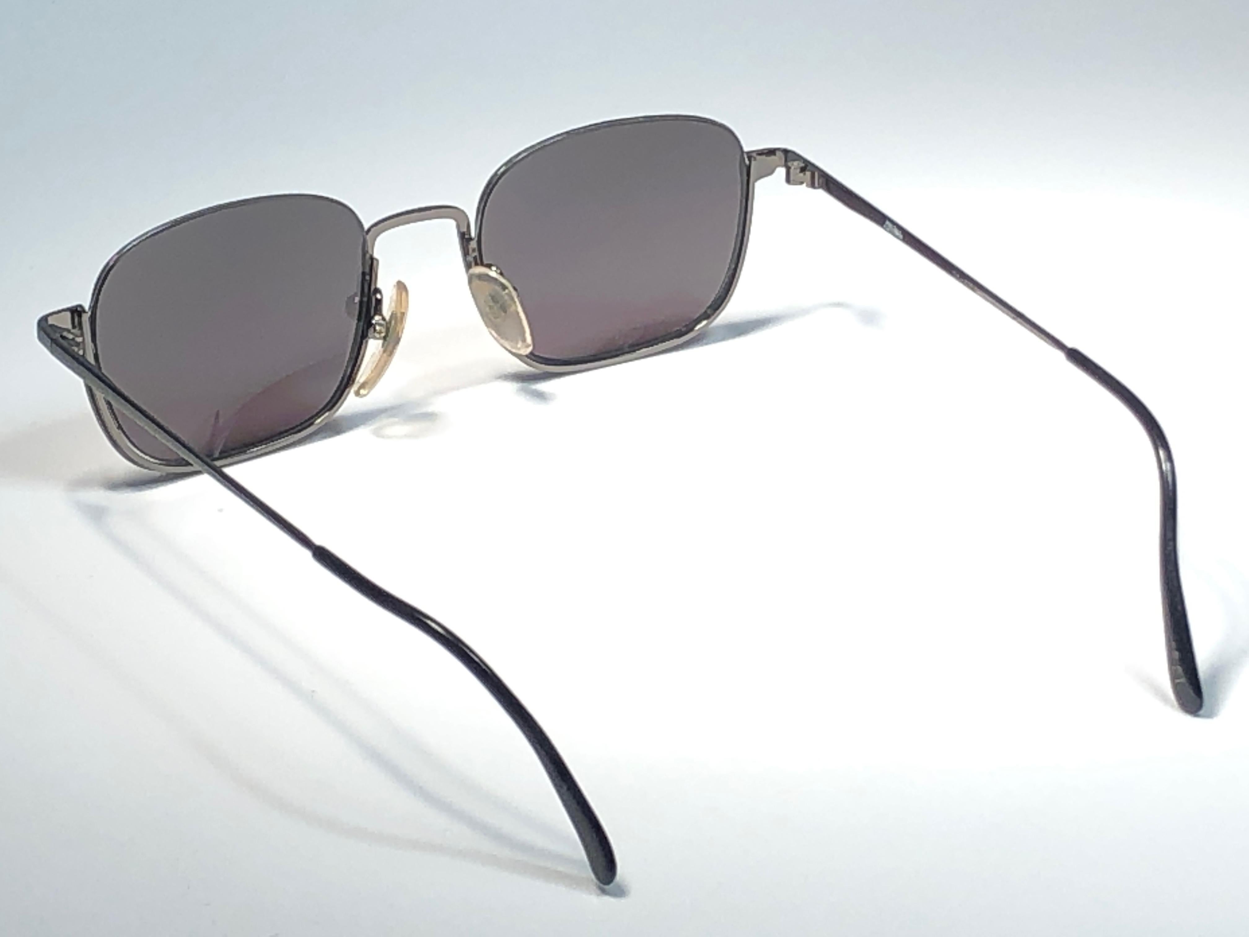 New Jean Paul Gaultier medium half frame grey sunglasses.
Spotless smoke grey lenses that complete a ready to wear JPG look.

Amazing design with strong yet intricate details.
Design and produced in the 1990's.
New, never worn or displayed.
This