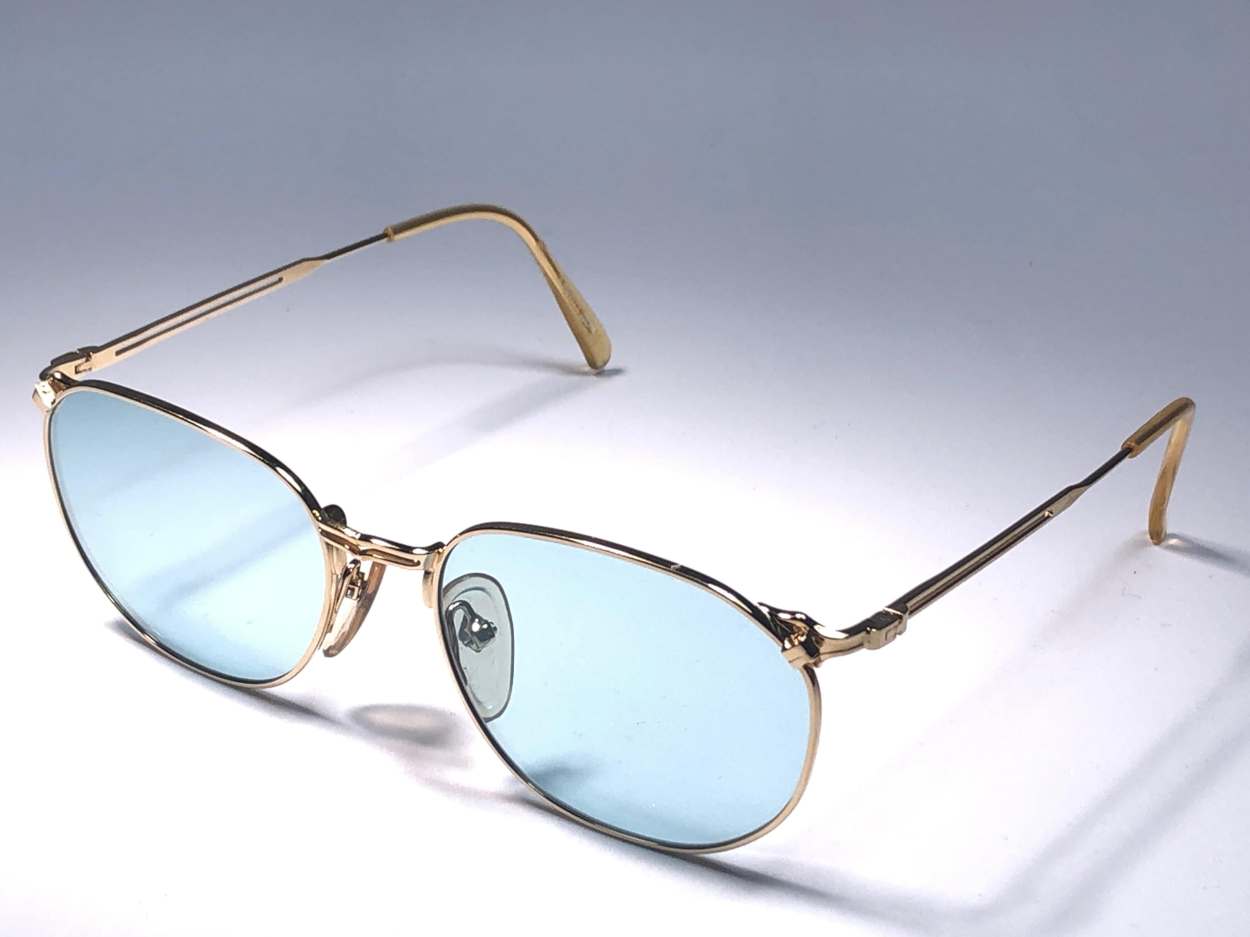 New Jean Paul Gaultier Medium gold frame sunglasses.
Light green lenses that complete a ready to wear JPG look.

Amazing design with strong yet intricate details.
Design and produced in the 1990's.
New, never worn or displayed.
This item may show