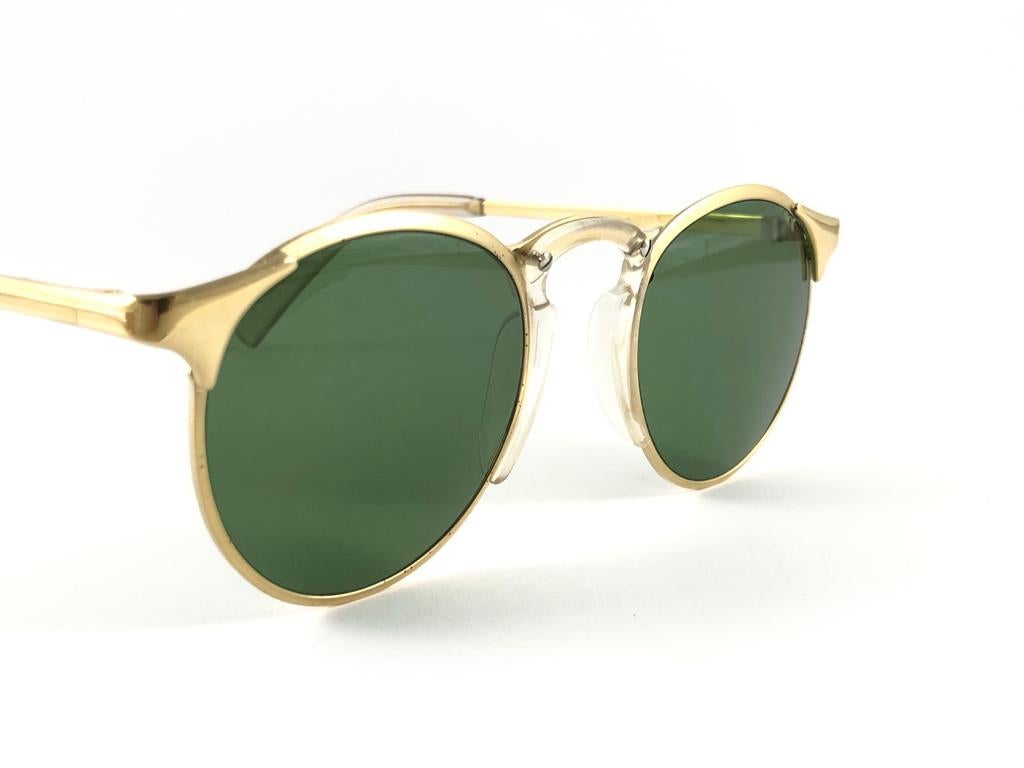 New Jean Paul Gaultier gold frame sunglasses.
Spotless green lenses that complete a ready to wear JPG look.

Amazing design with strong yet intricate details.
Design and produced in the 1990's.
New, never worn or displayed.
This item may show minor