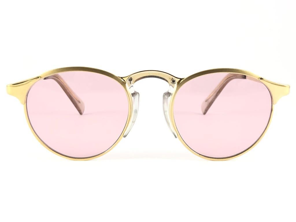 New Jean Paul Gaultier gold frame sunglasses.
Spotless light pink lenses that complete a ready to wear JPG look.

Amazing design with strong yet intricate details.
Design and produced in the 1990's.
New, never worn or displayed.
This item may show