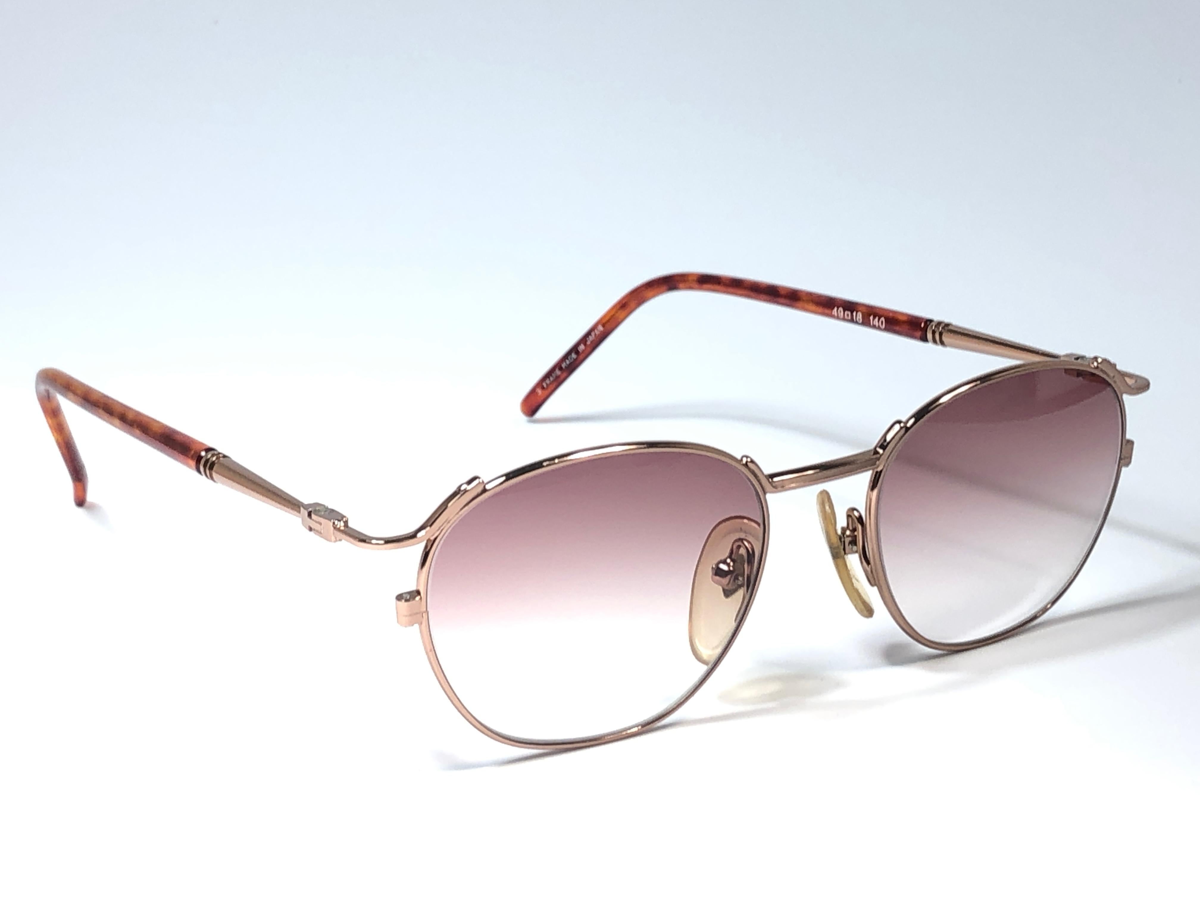 New Jean Paul Gaultier medium rose gold frame. 
Spotless light gradient rose lenses that complete a ready to wear JPG look.

Amazing design with strong yet intricate details.
Design and produced in the 1990's.
New, never worn or displayed.
A true