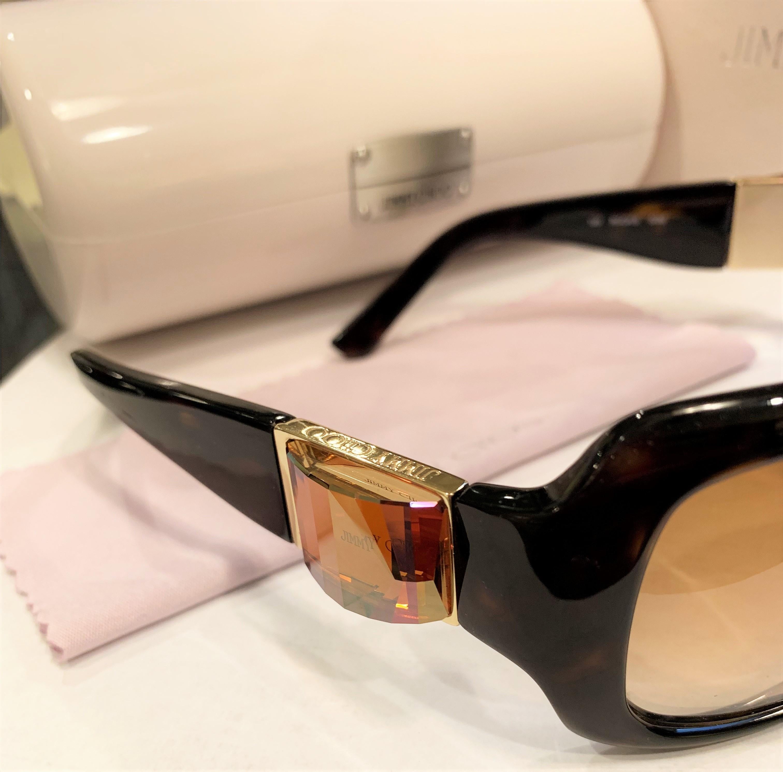 Jimmy Choo
Brand New
*Stunning in Dark Brown
* Gold Hardware
* Swarovski Crystal at Temples
* Resin Frames
* ROCK/S 
* Made in Italy
* 100% UVA/UVB Protection
* Comes with Case, Cleaning Cloth & Box