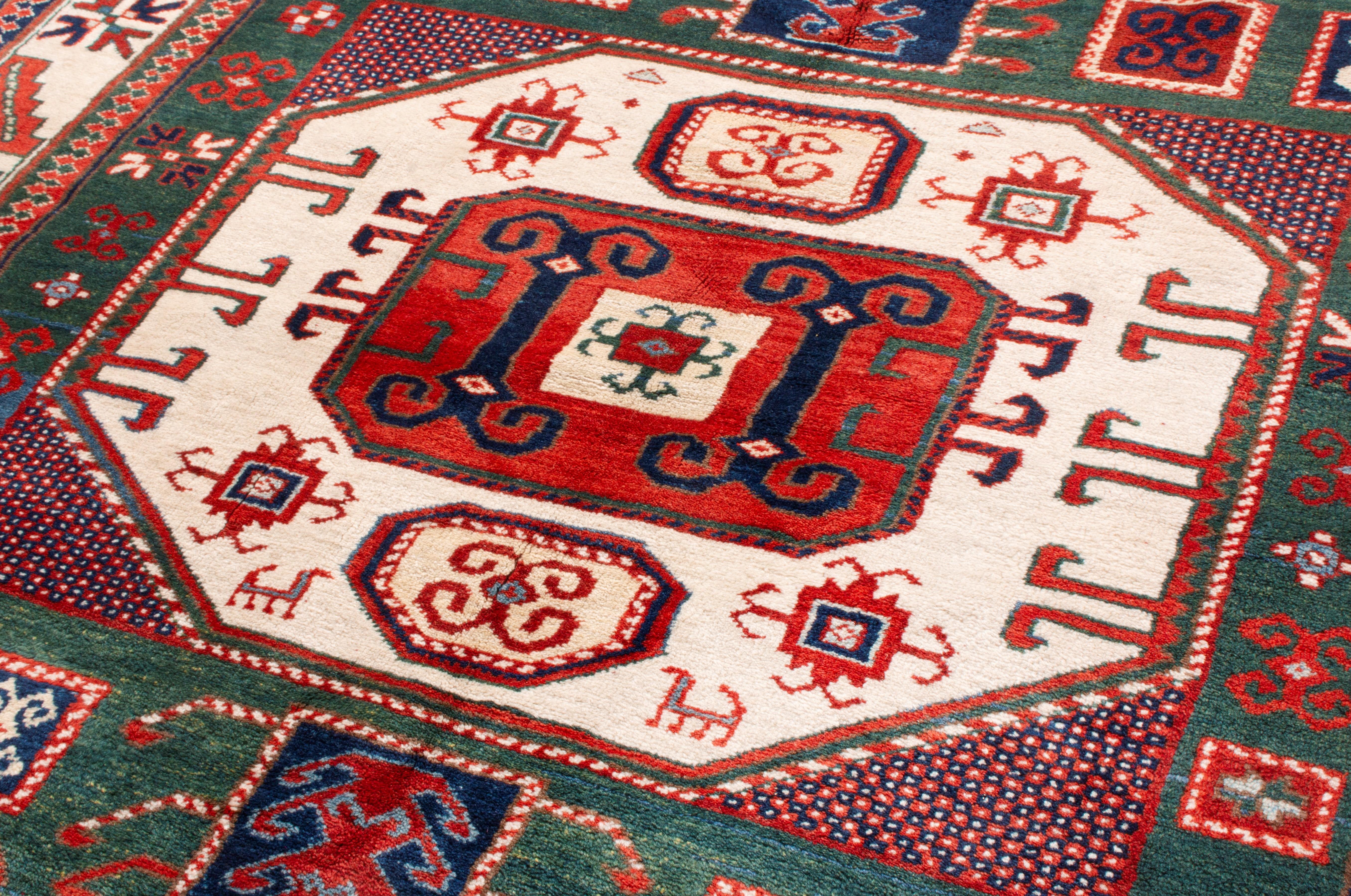 Turkish Rug & Kilim's New Kazak Transitional Red and Green Wool Rug with Horn Motifs For Sale