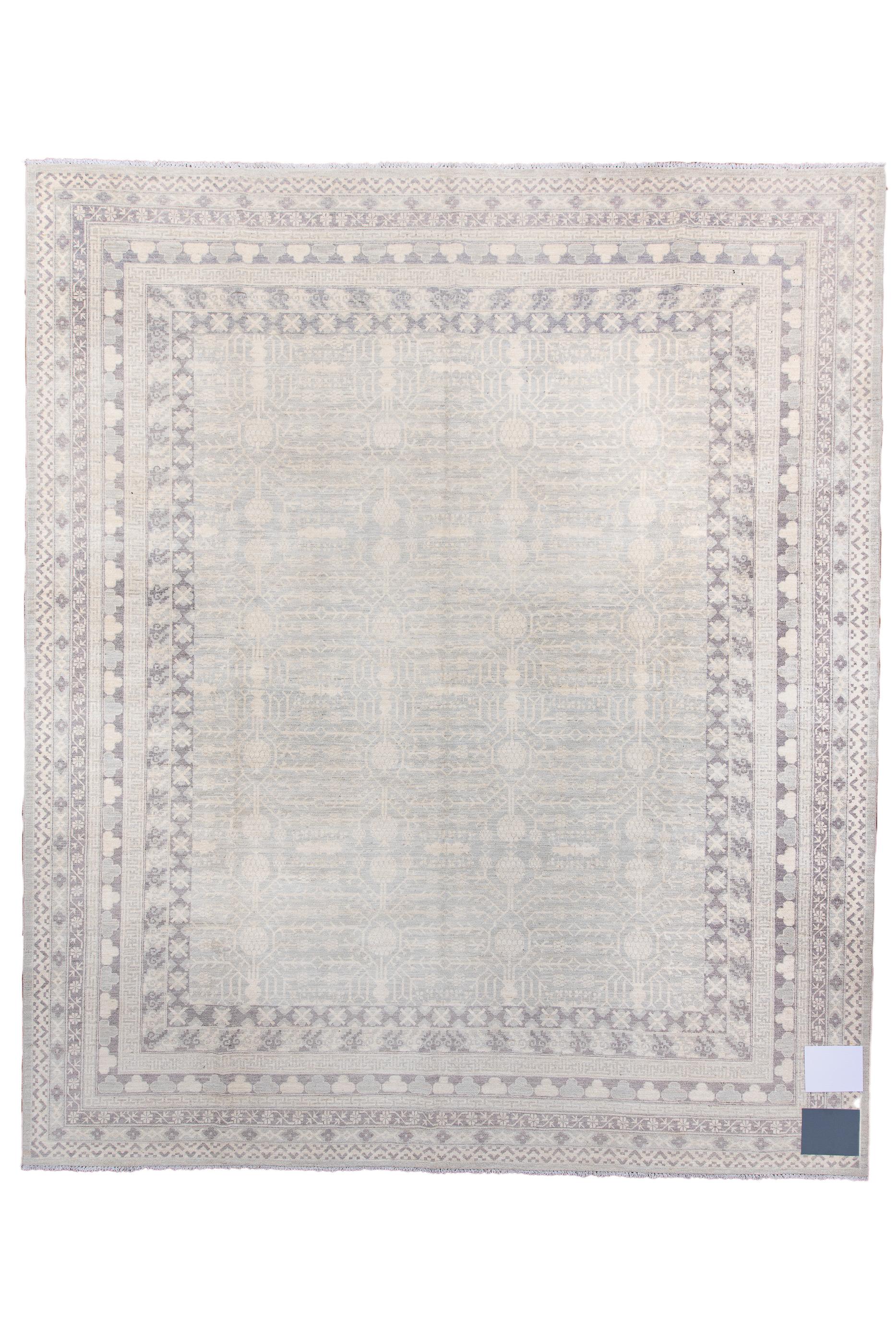 From Western China, this nearly square city carpet features a lightly drawn vase and pomegranate design on a pale straw field.  The nine borders include zig-zags, chains of cartouches with stars, and rows of cloud knots. The tonality is generally