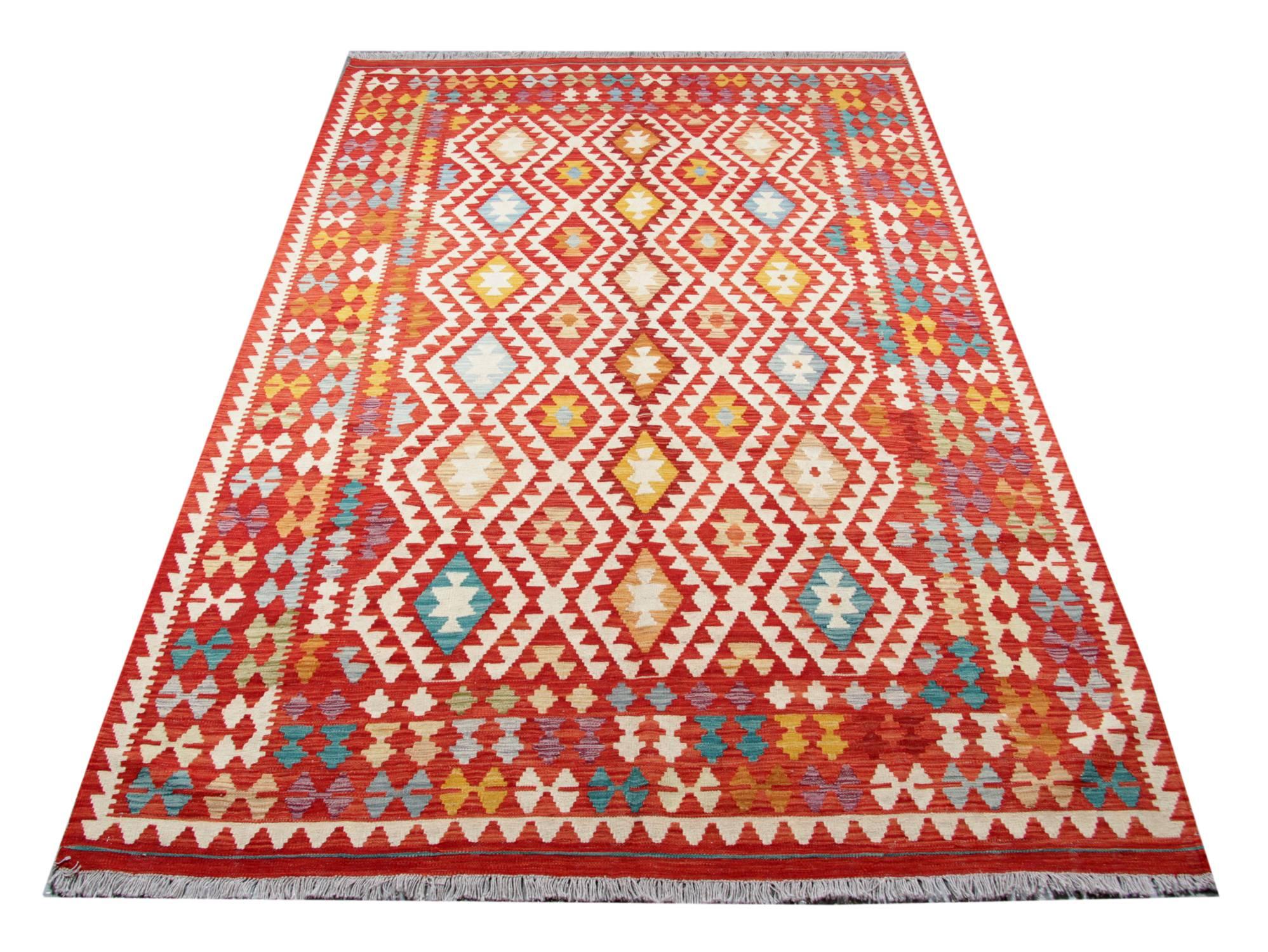 This is an oriental rug flat-weave rug woven by very skilled weavers in Afghanistan, who used the highest quality wool and cotton. This orange rug has red, orange, white, blue and yellow colors. The border of this woven rug has small and colorful
