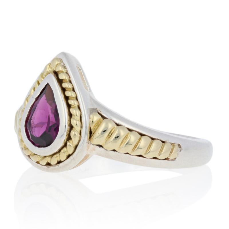 This lovely new ring is a Krementz piece composed of sterling silver with 18k yellow gold accents. The ring features a teardrop setting with a bezel set genuine rubellite tourmaline displayed at the center. The setting is framed by 18k scalloped