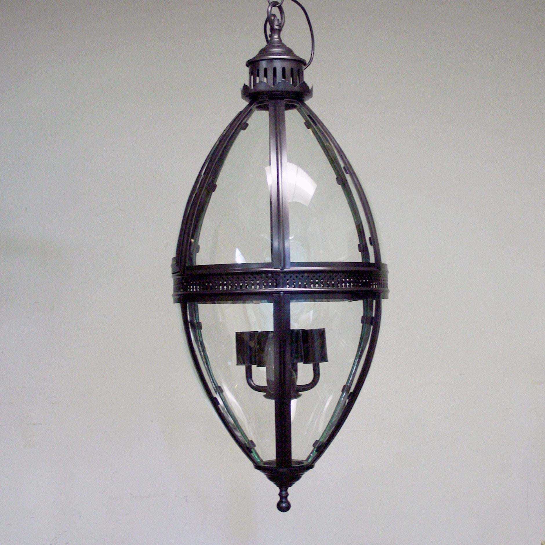 A reproduction oval shaped hanging lantern with curved glass panels, comes in a black and brass colored finish.

Have 4 of each color in stock so would work perfectly for a bar/restaurant project or great as a single piece for an interior