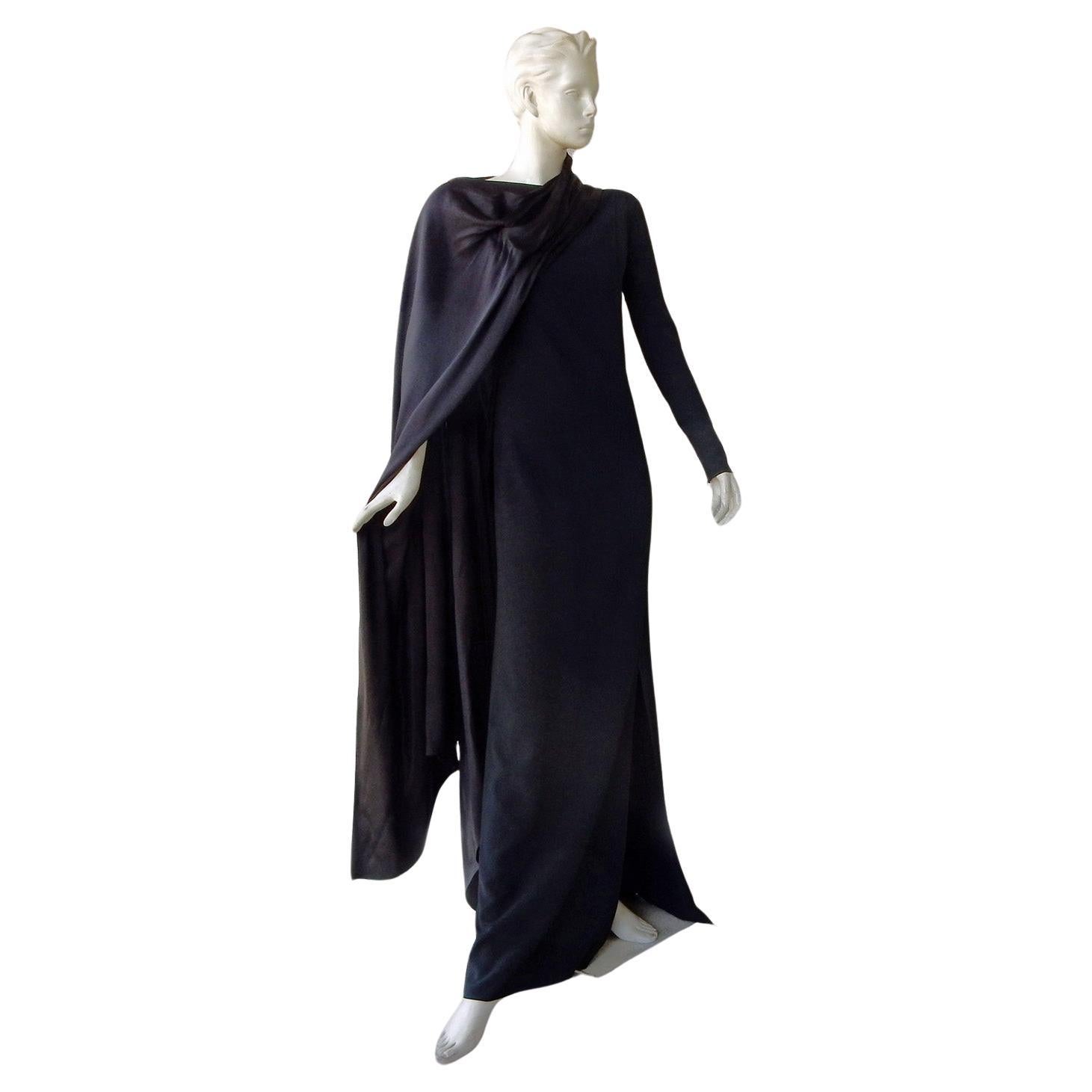 Schiaparelli rare limited edition bias cut gown from the 2021 collection by Daniel Roseberry. Black silk long sleeve cowl neck with cape overlay. Single sleeve with zipper wrist. Side zipper closure.  Makes a dramatic distinctive stylish entrance