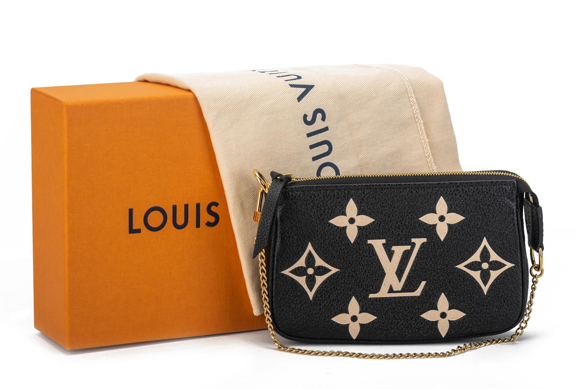 Louis Vuitton mini pochette in black leather with embossed logo in blush, gold tone hardware. Gold tone hardware chain. Brand new with original dust cover and box.
