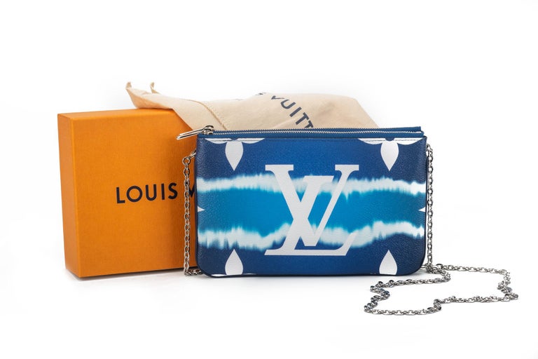 Louis Vuitton double pouchette in coated monogram canvas with tie die blue pattern. Double zipped compartments with middle open pocket, can be used as a pochette or as a cross body. Comes with original dust cover and box. Never worn.
