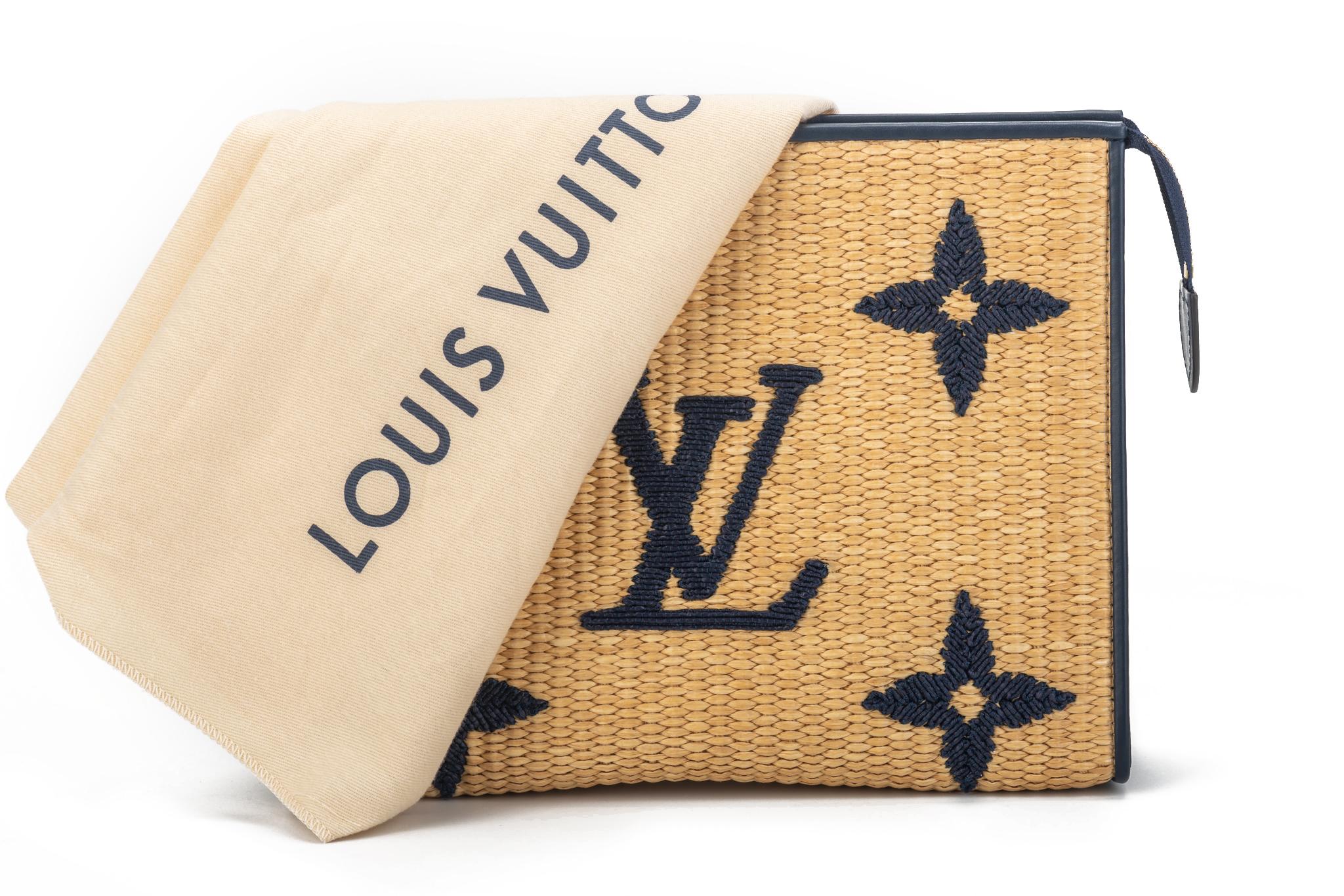 Louis Vuitton limited edition raffia clutch with navy blue leather trimming and oversize embroidered logo. Striped fabric interior lining. Brand new with original dust cover and box.
