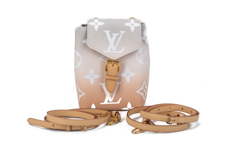 Louis Vuitton hot season ticket two way mini backpack that can be converted in fanny pack or cross body bag. Blush ombre' coated monogram canvas and gold tone hardware. Sold out worldwide. Comes with dust cover and original box.
