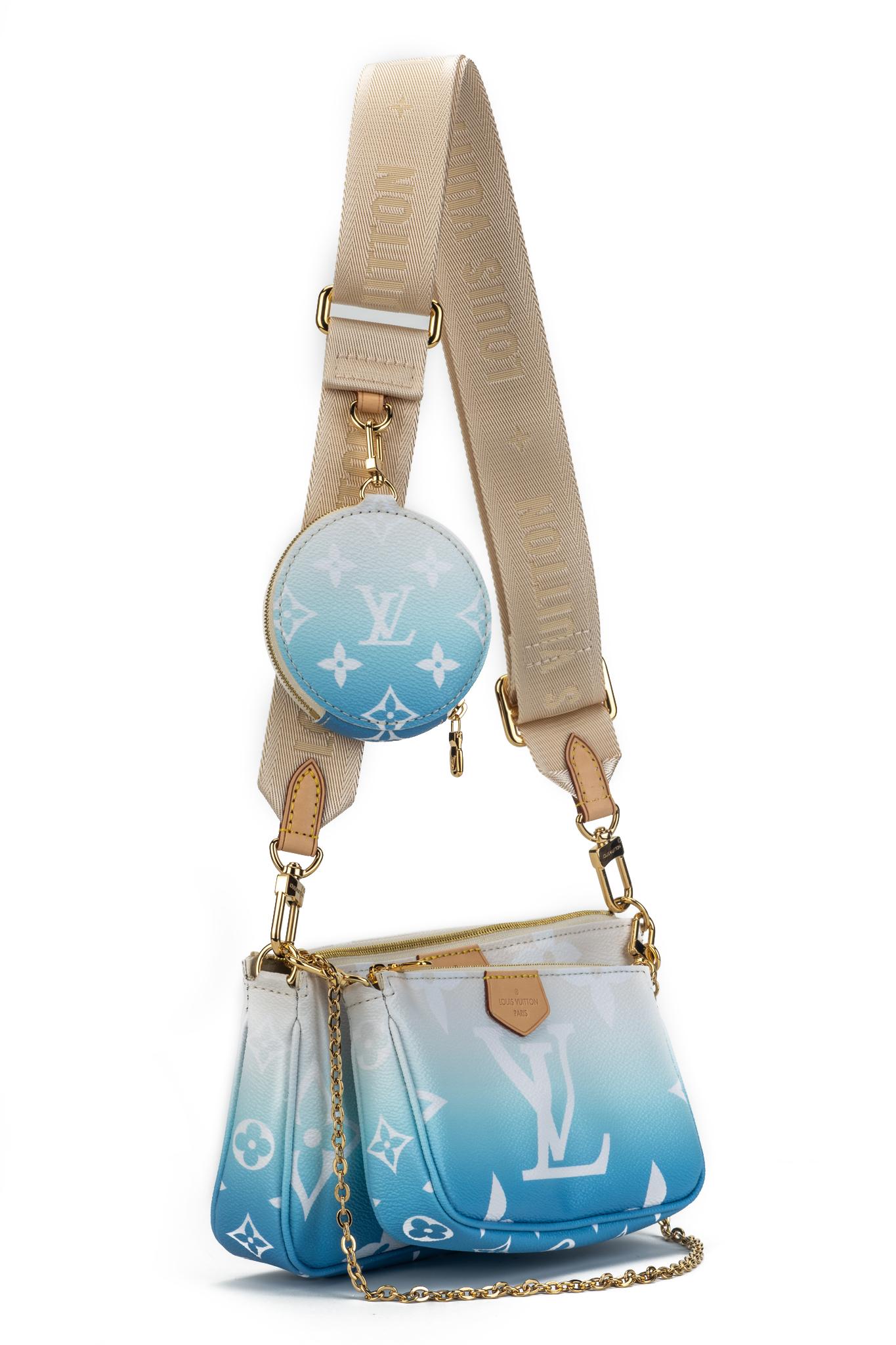 Louis Vuitton hot season ticket multi pochette in coated monogram degrade' blue canvas and gold detail. Sold out worldwide. Composed of three detachable parts: cross body, pochette and round coin purse. Adjustable strap. Comes with dust cover and