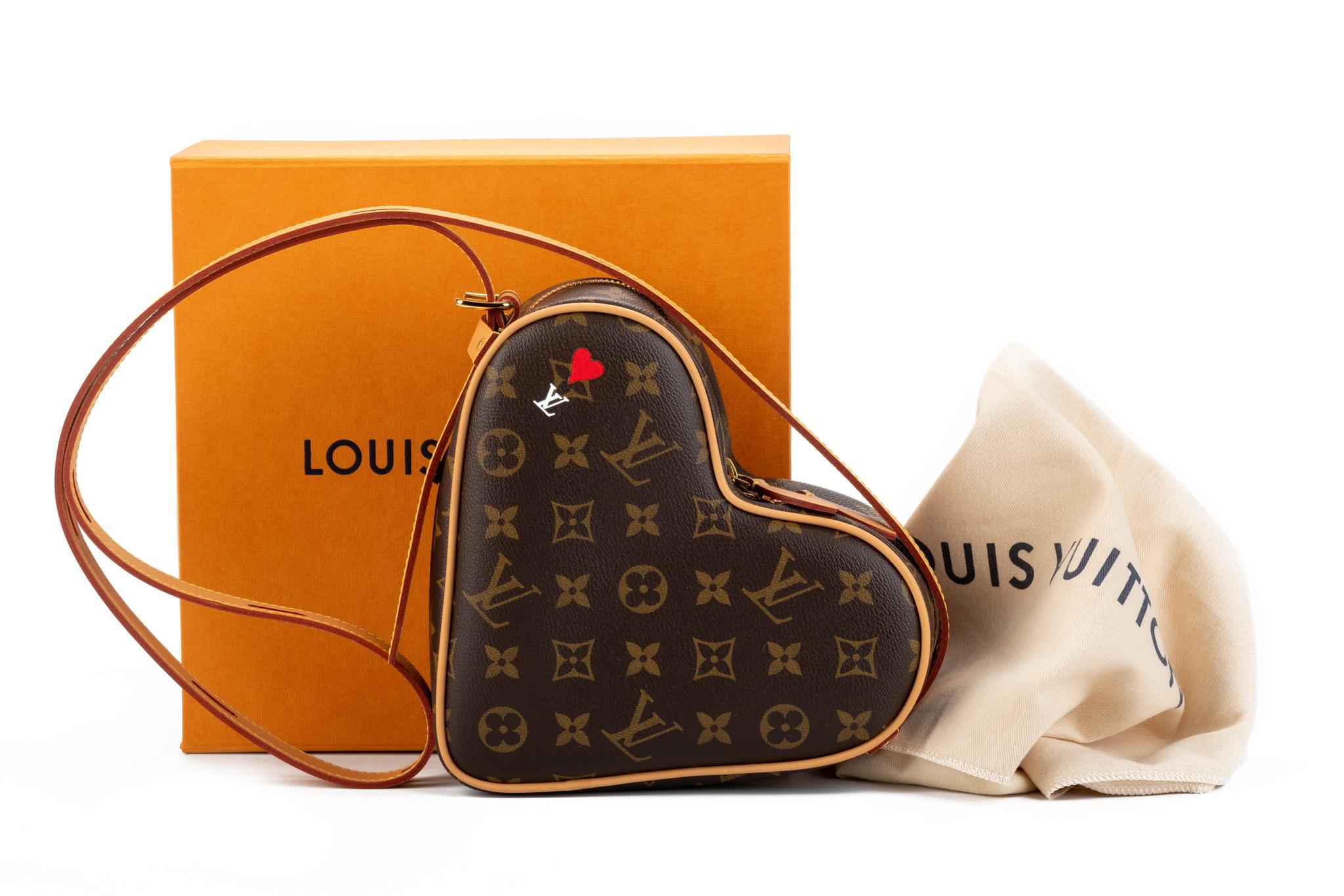 Louis Vuitton limited edition heart shaped cross body bag. Classic monogram print with heart painted detail. Adjustable strap. Shoulder drop 21