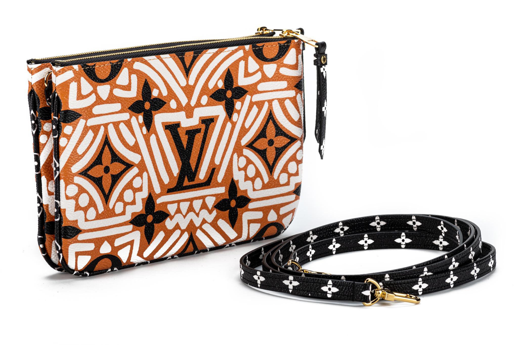 Louis Vuitton limited edition tribal coated canvas double zipper cross body bag. Multiple pockets and removable straps. Brand new with dust cover and box.