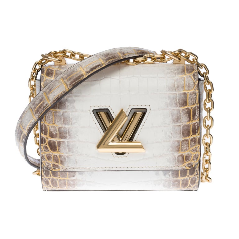 This Exceptional and precious Twist Mini bag in white Crocodile leather from Niloticus is embellished with the LV Twist clasp and the nautical chain that characterize the classic Twist model. Ideal for the evening, this adorable, small handbag can