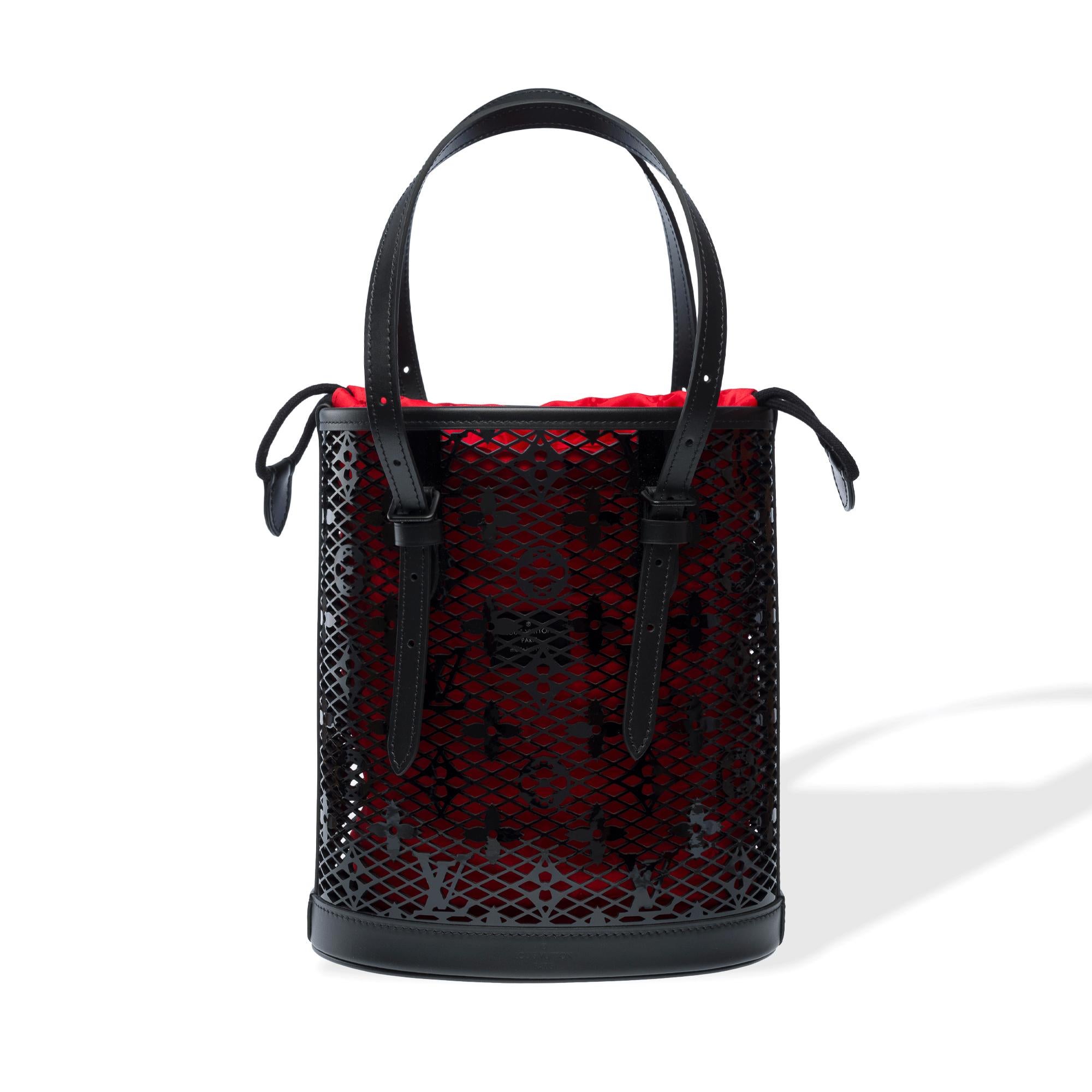 Stunning​ ​Louis​ ​Vuitton​ ​Race​ ​limited​ ​edition​ ​Bucket​ ​bag​ ​in​ ​black​ ​patent​ ​leather​ ​monogram​ ​lace,​ ​blackened​ ​metal​ ​trim,​ ​adjustable​ ​black​ ​leather​ ​handles​ ​allowing​ ​for​ ​shoulder​ ​or​ ​crossbody​
