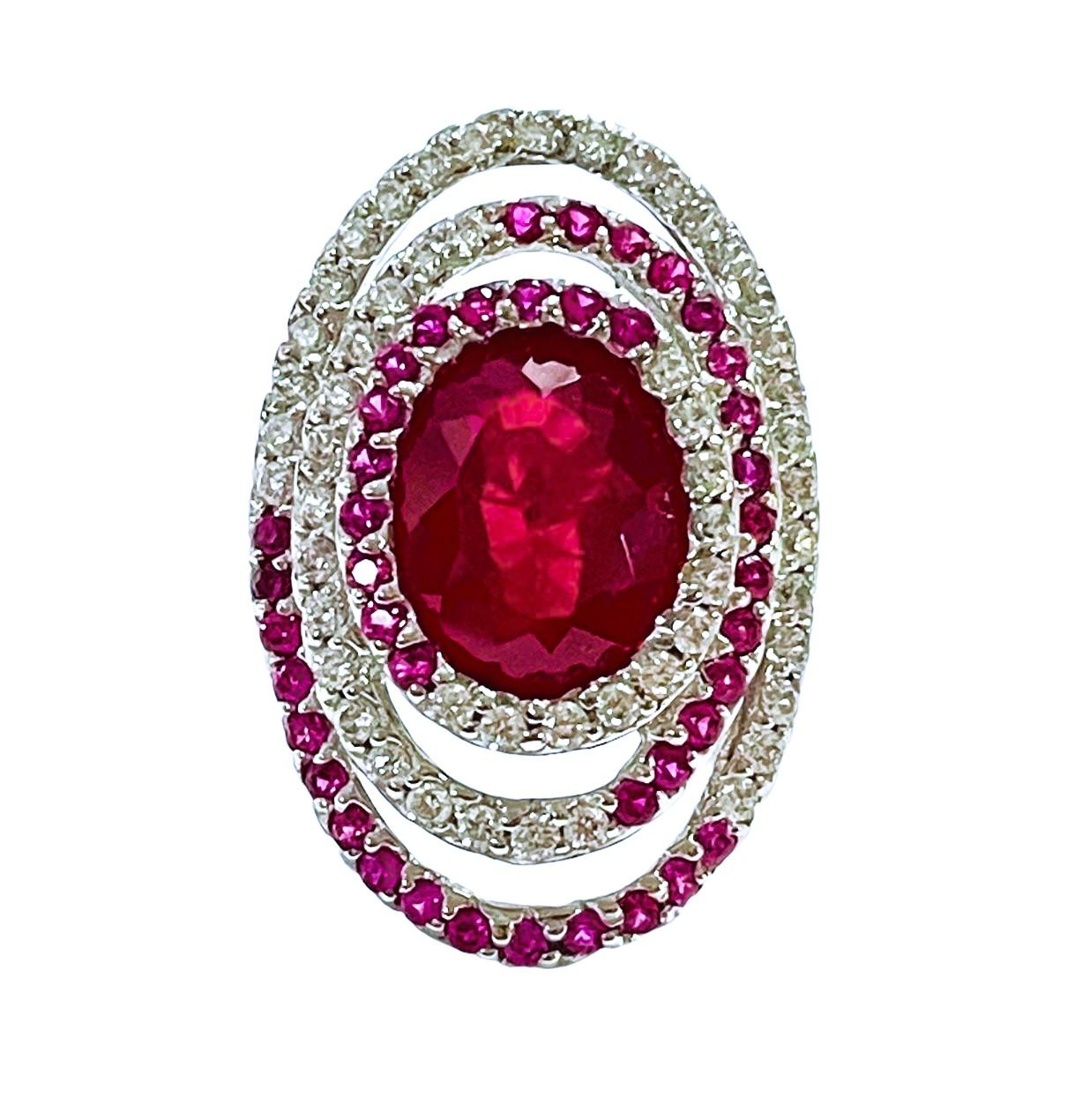 What a gorgeous ring!  The ring is a size 6.   It was mined in Africa and is just exquisite. It is an oval cut stone and is 7.0 Cts   The main stone is 12 x 9 mm. It has diamond cut Pink Rubies and White Sapphire stones that swirl around the main