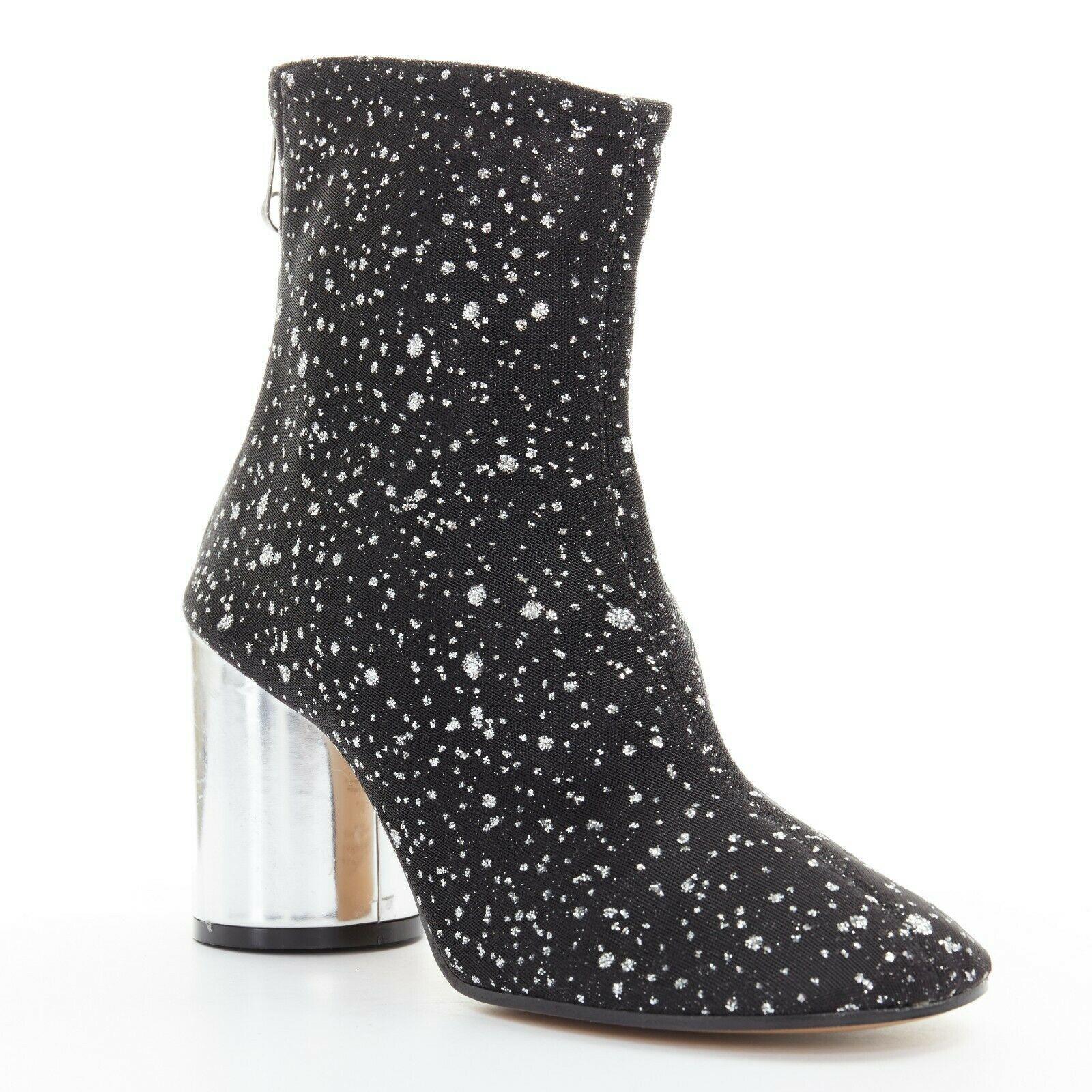new MAISON MARGIELA black mesh speckle glitter silver chunky heel bootie EU39

MAISON MARGIELA
Black mesh upper. Silver speckle glitter. Round toe. Ankle length shaft. Silver leather covered cylindrical chunky heel. Zip back closure. Paper clip
