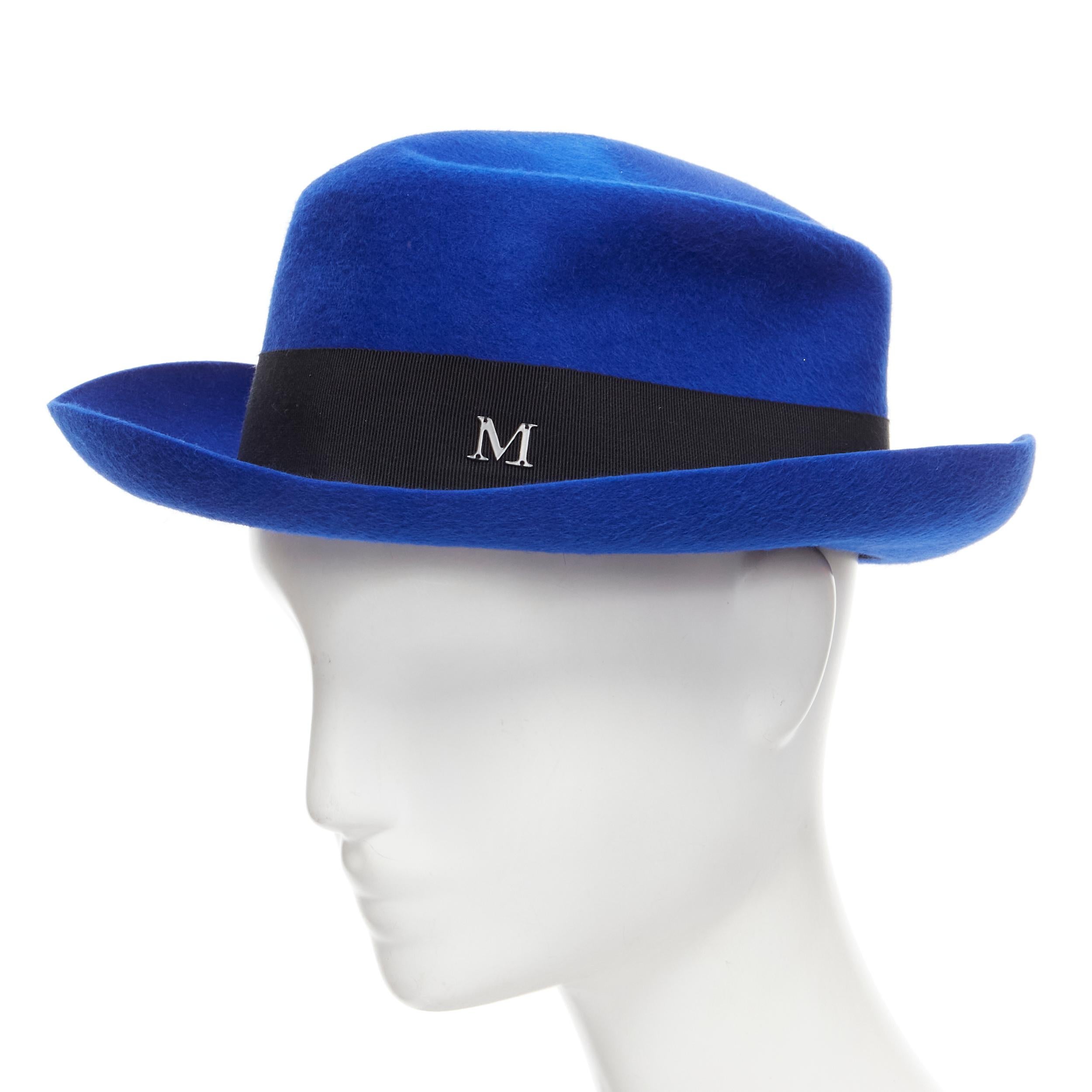 new MAISON MICHEL Tiger cobalt blue wool felt black grosgrain metal logo fedora hat 57cm 
Reference: MELK/A00154 
Brand: Maison Michel 
Material: Wool 
Color: Blue 
Pattern: Solid 

CONDITION: 
Condition: New with tags. 

SIZING: 
Designer Size: