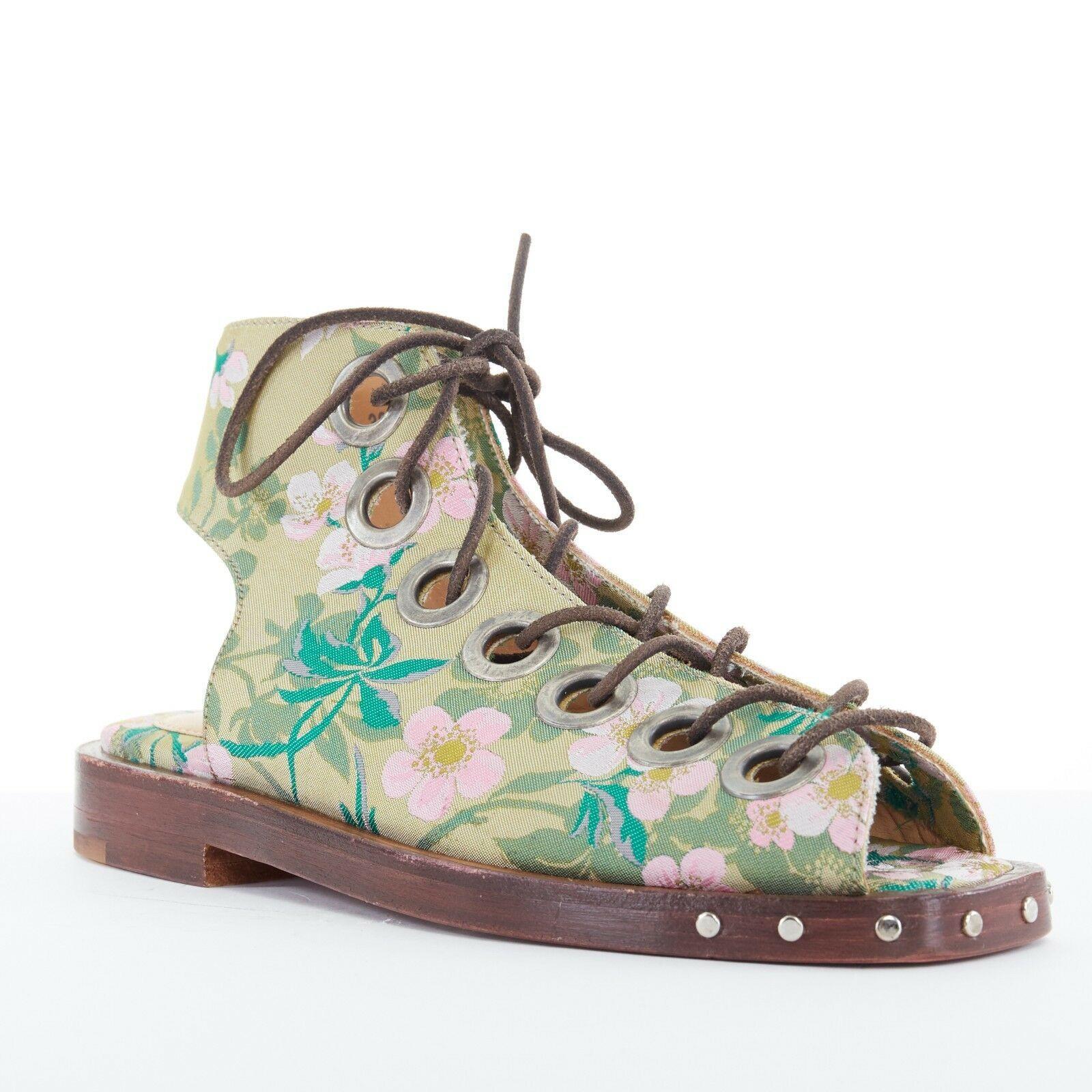 new MARQUES ALMEIDA green floral jaquard open toe eyelet lace flat sandal EU38

MARQUES ALMEIDA
Green and pink floral jacquard fabric upper. Open toe. Square toe. Black suede leather lace. Intentional aged copper-tone eyelet details. Cut out at