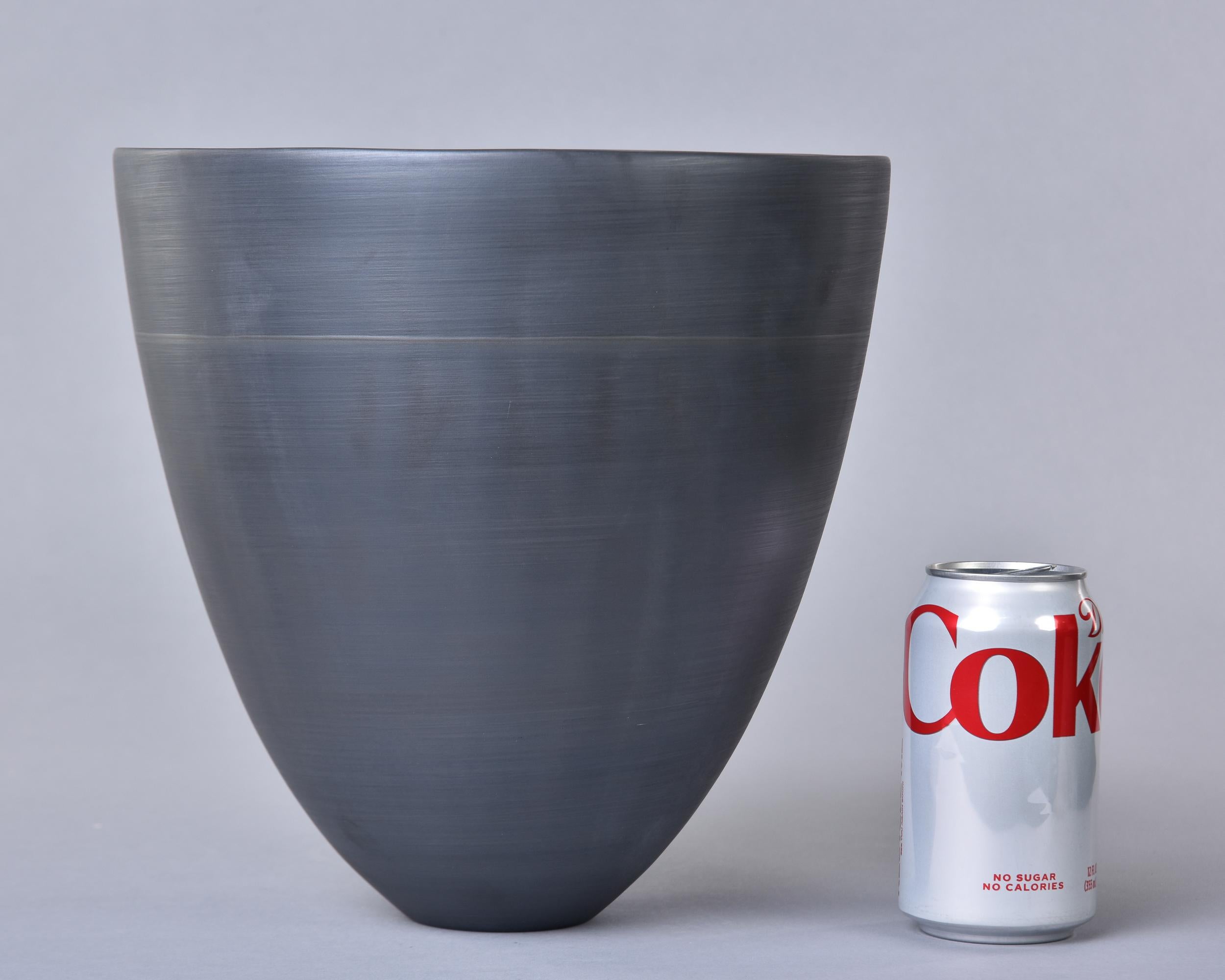 Diese neue, in Italien von Rina Menardi handgefertigte Schale oder Vase in Form eines Bechers ist knapp 30 cm hoch und in einem weichen Schwarz glasiert. Stromlinienförmige Form mit dünnen, glasierten Porzellanwänden und der gleichen schwarzen