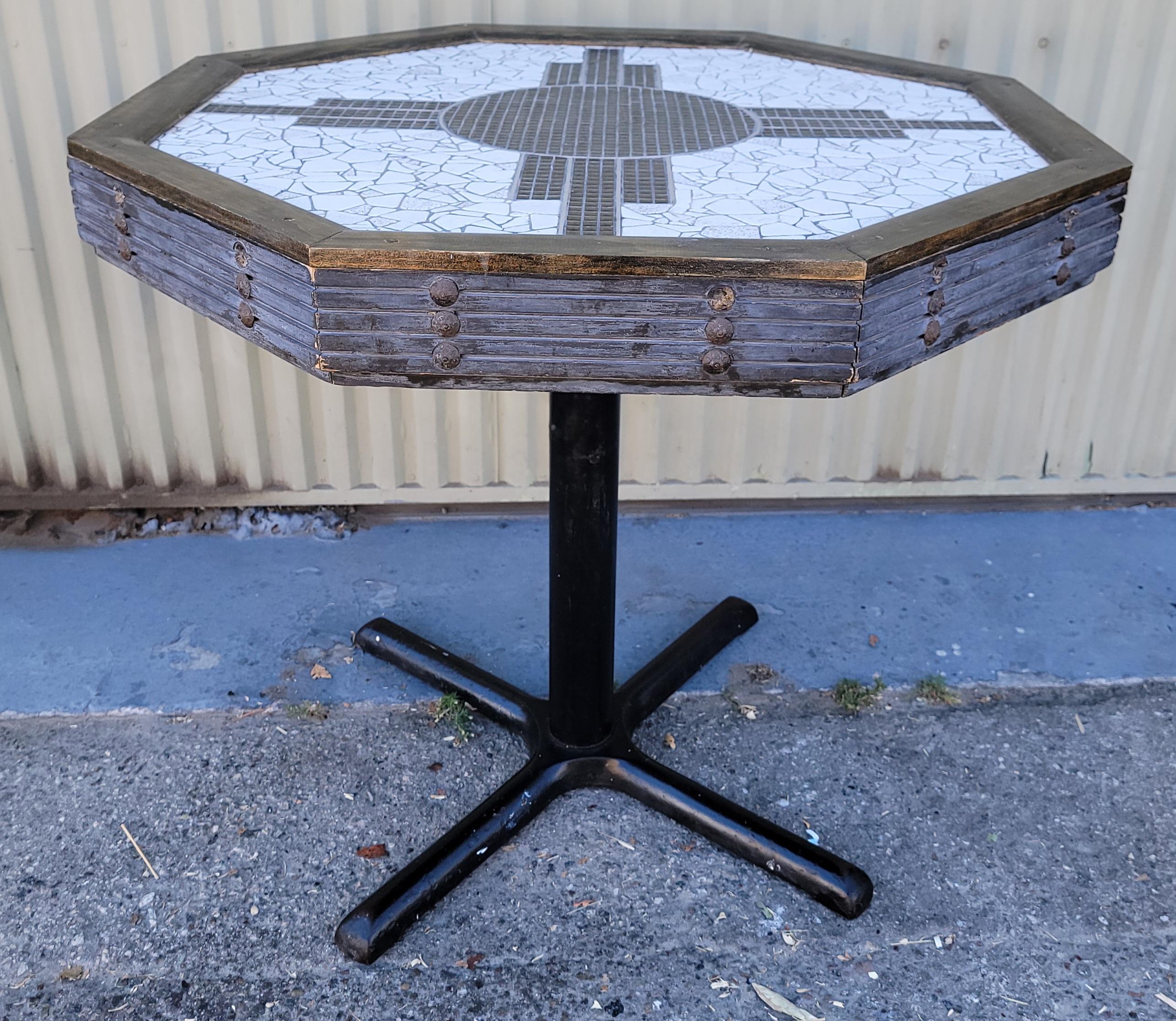 This fine inlaid pedestal table has custom inlaid tiles with the New Mexico sign on top.The base is in a blue pieced wood similar to tramp art with a iron pedestal  footed base.This was made in New Mexico from a N.M artist.This is a real investment
