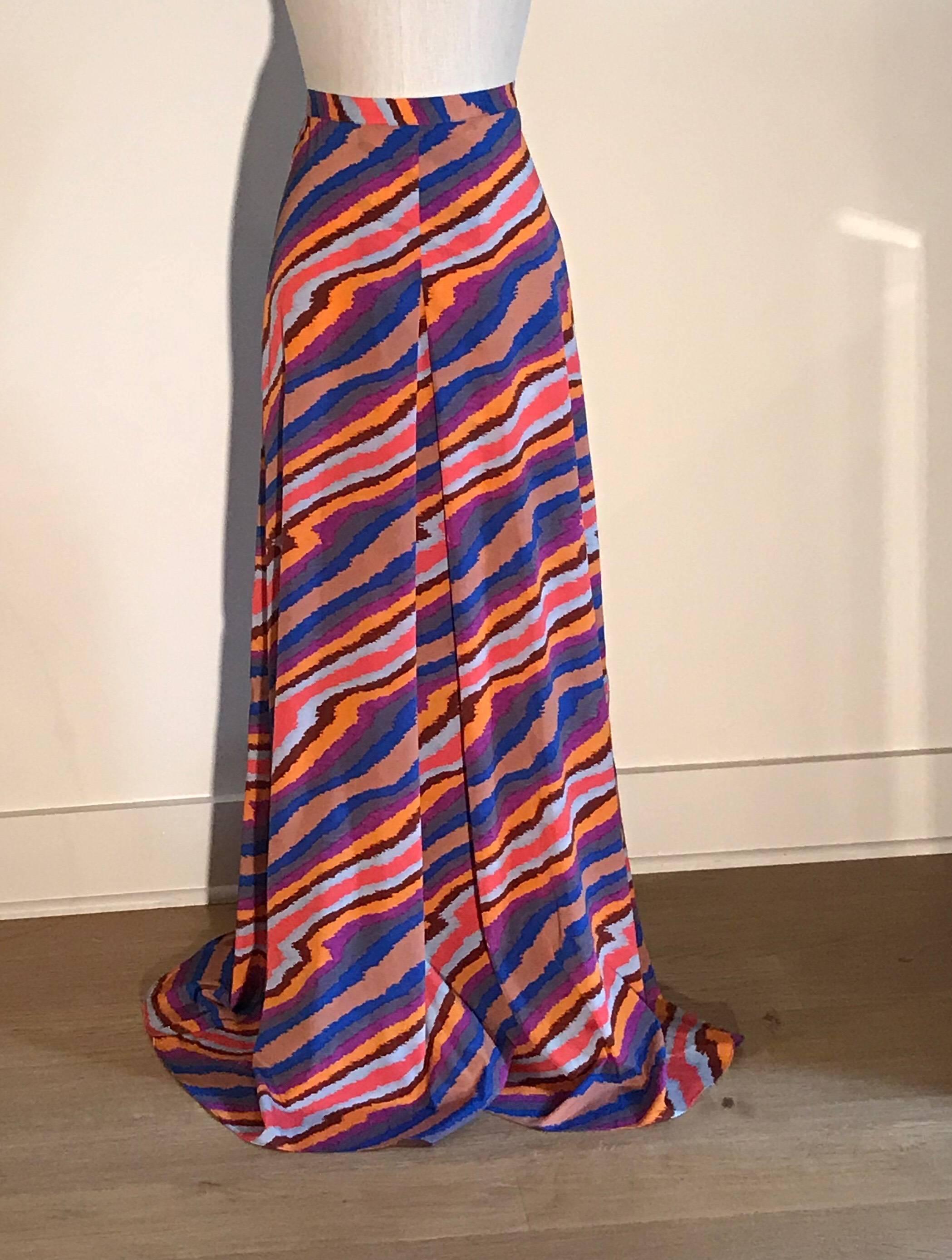 Missoni lightweight maxi skirt in a painterly stripe pattern in shades of sand, orange, maroon, fuchsia, grey, and blue. Side zip with two snaps at waist band.

96% silk, 4% elastane. Unlined.

Made in Italy.

Size IT 40, approximate US 4. See