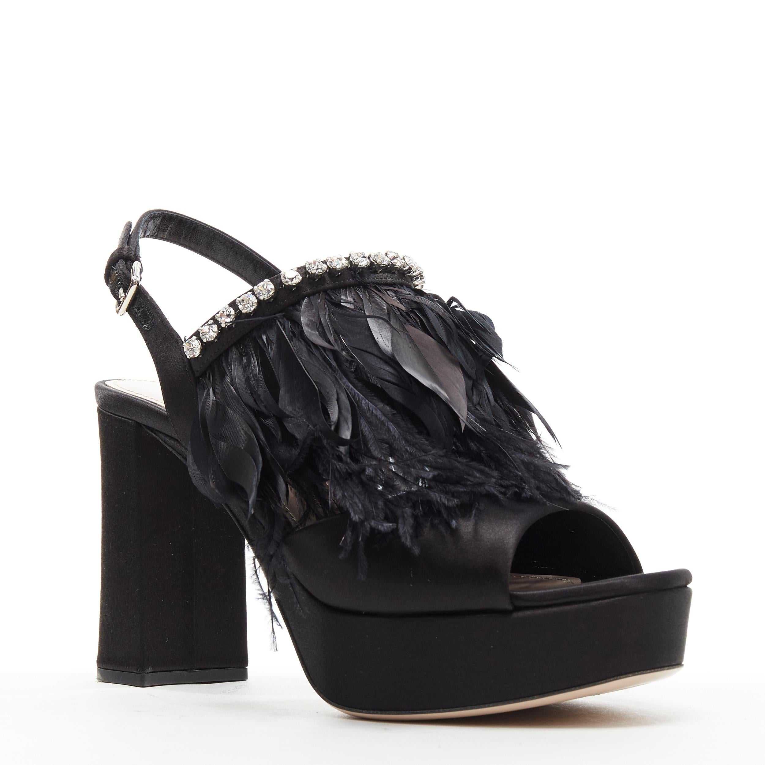 new MIU MIU black satin feather crystal embellished platform heel sandals EU37 
Reference: TGAS/B00645 
Brand: Miu Miu 
Designer: Miuccia Prada 
Model: Crystal Feather satin platform heels 
Material: Silk 
Color: Black 
Pattern: Solid 
Closure: